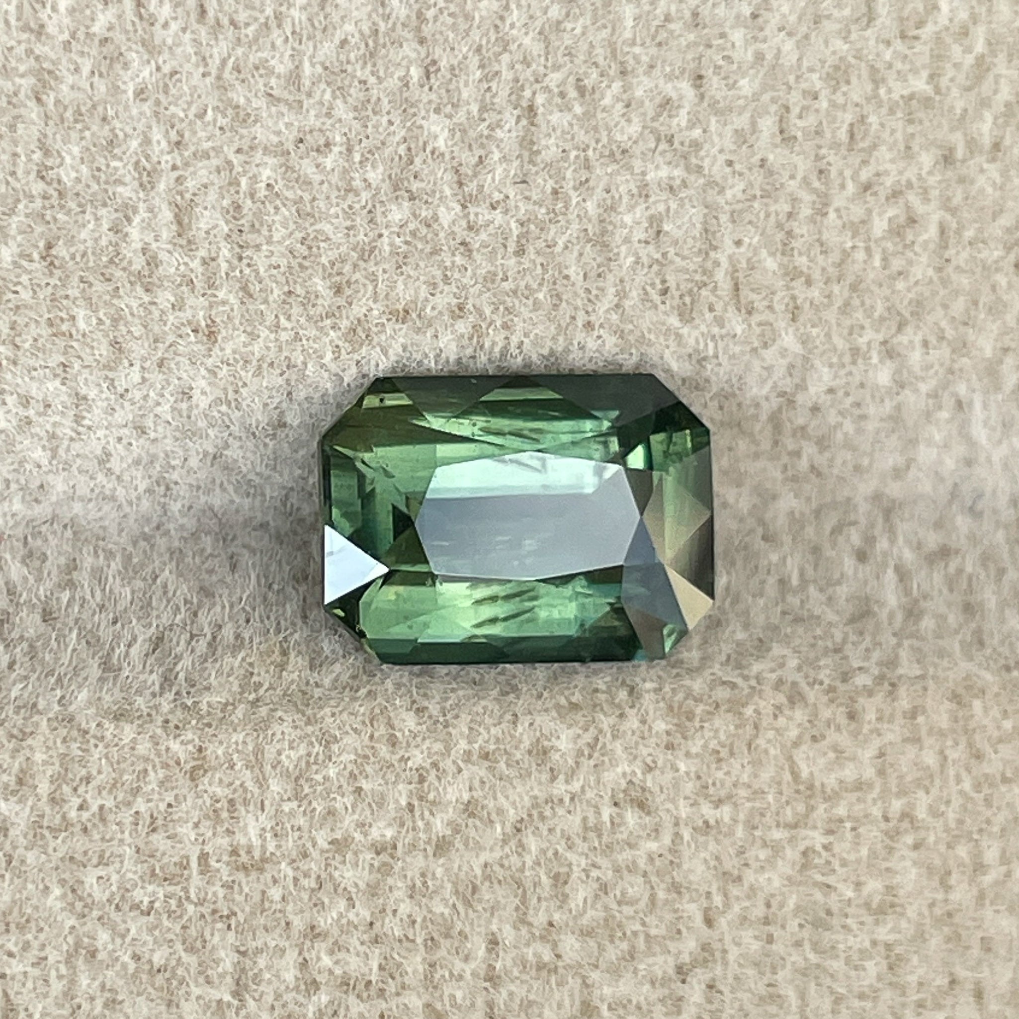 Teal green 2.36 Ct radiant cut natural sapphire from NASHGEMS, heat-treated loose gemstone for engagement or custom jewelry.