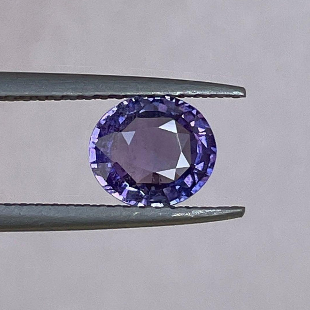 Loose violet sapphire gemstone with 1.28 carats, natural purple indigo mauve sapphire for custom jewelry design.