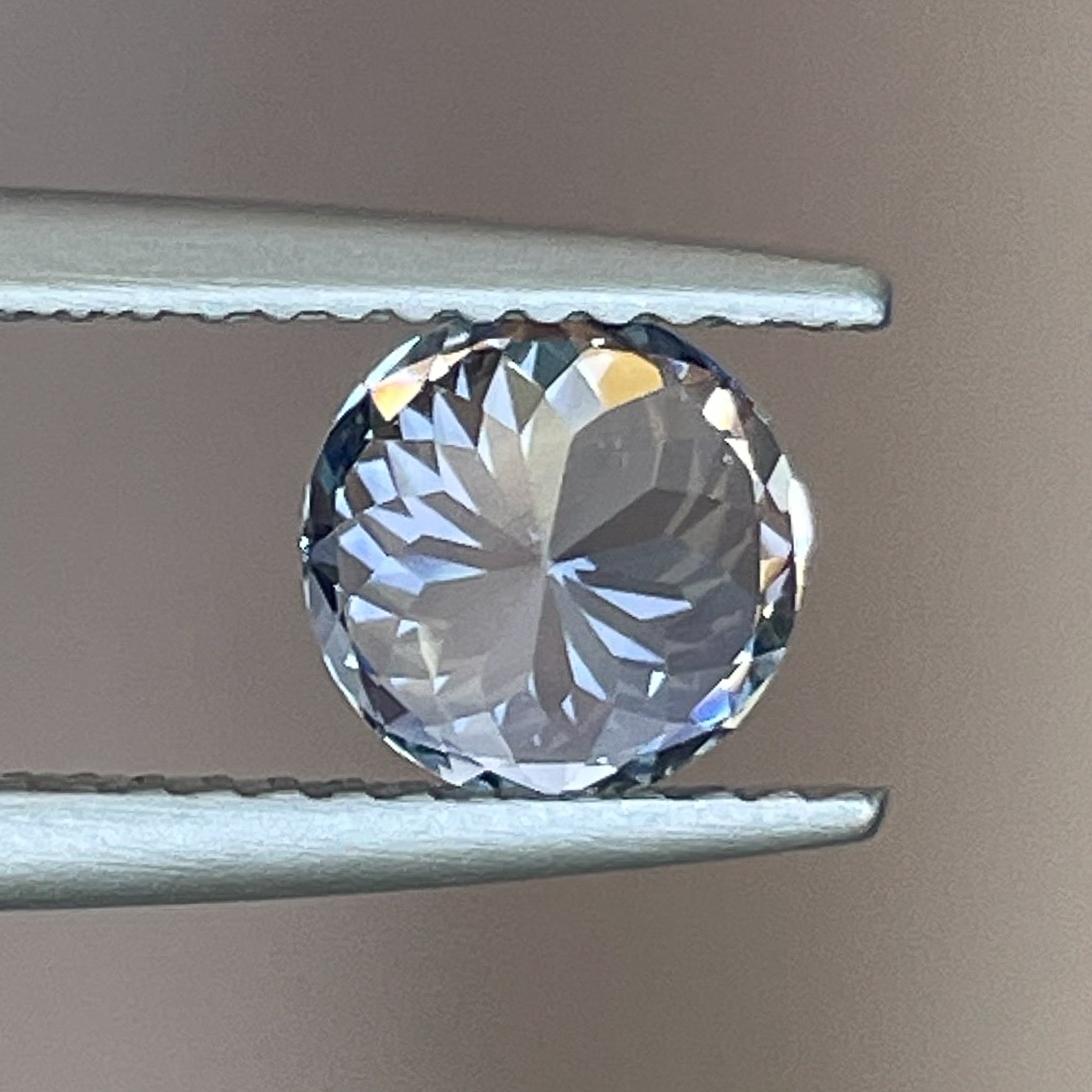 Natural Ceylon Pale Blue Sapphire 1.30 Ct round cut loose gemstone by NASHGEMS, showcasing its elegant blue color and clarity.
