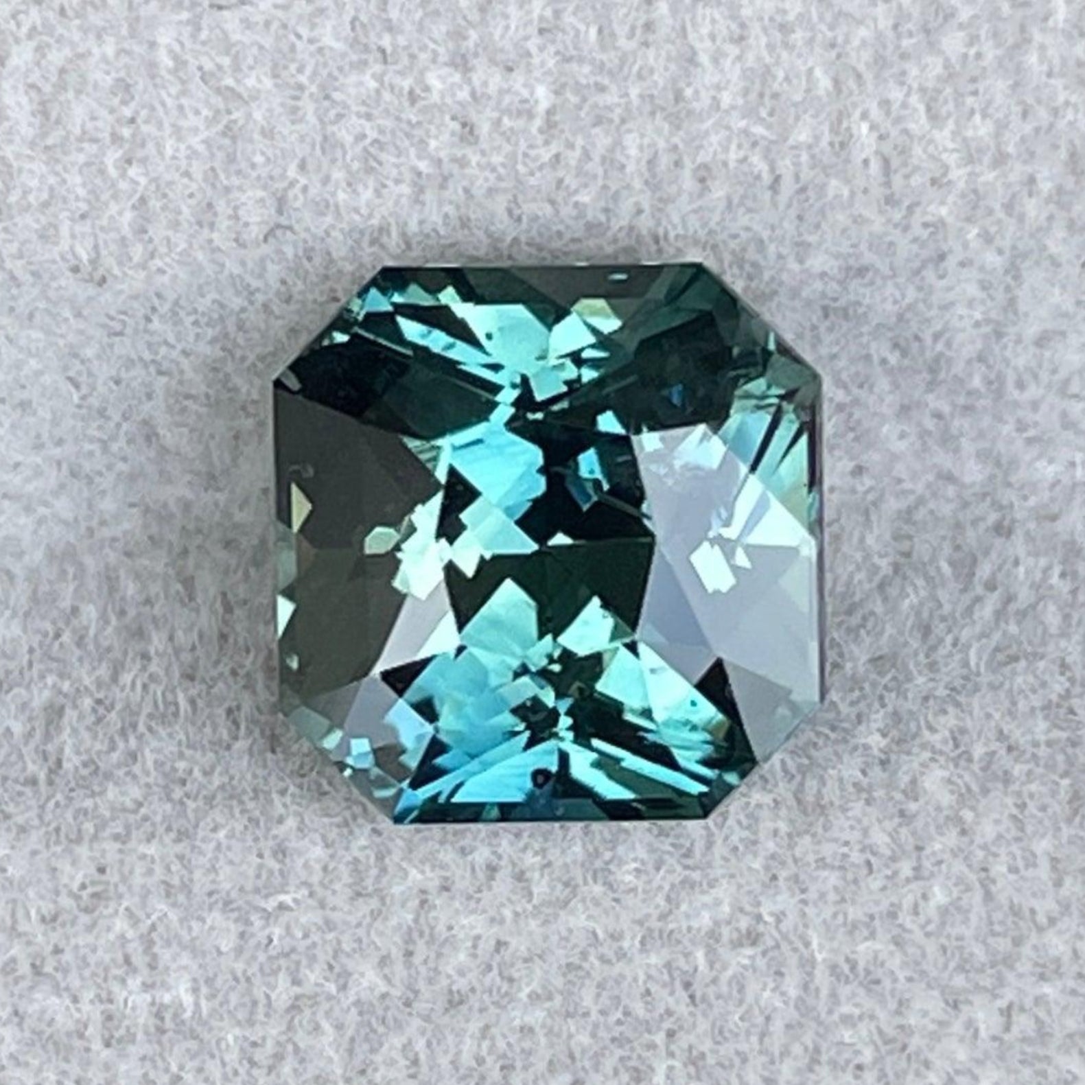 Blue-green teal sapphire loose stone, radiant cut 3.35 ct from NASHGEMS, ideal for anniversary or personalized engagement rings.
