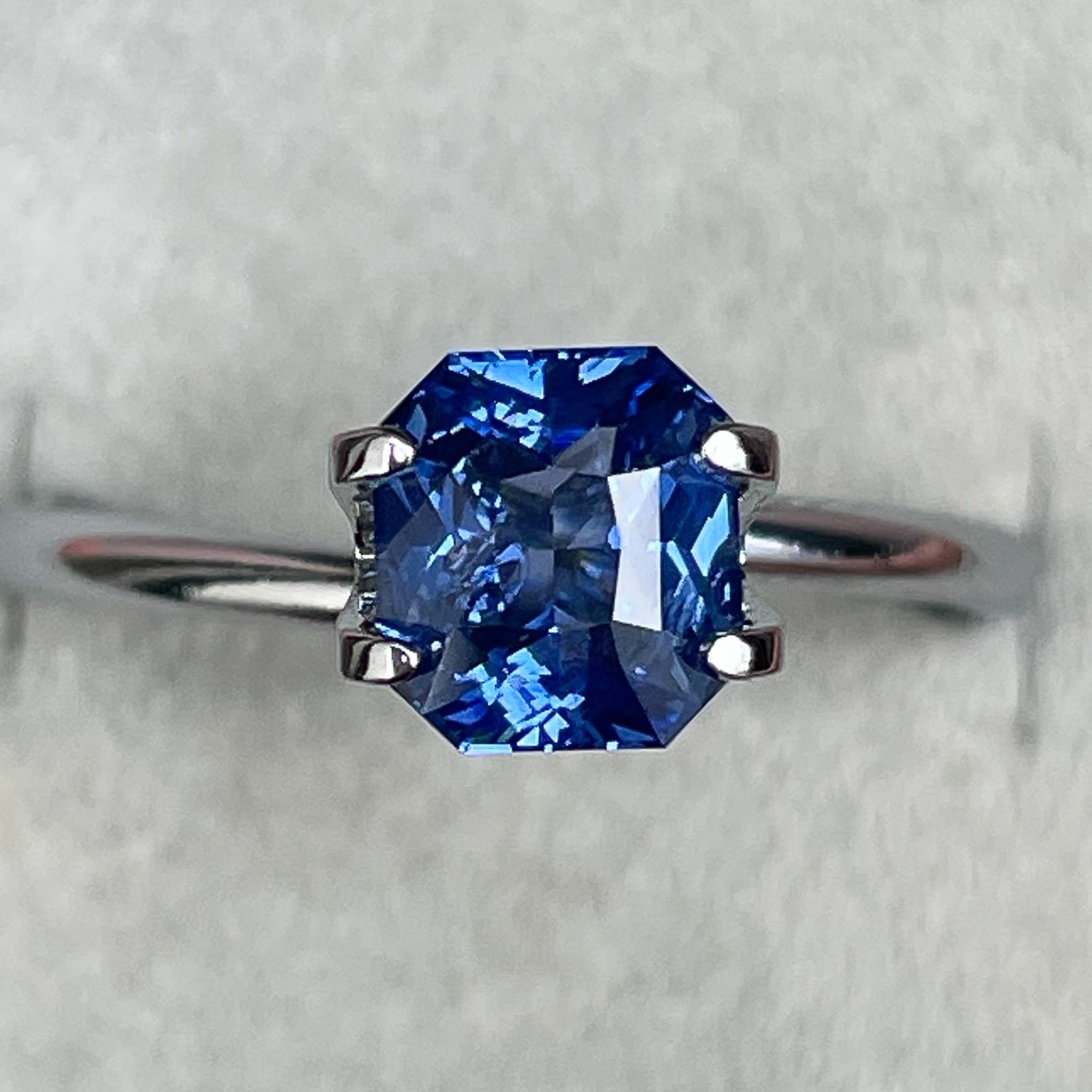 Natural Ceylon blue sapphire 1.52 Ct radiant cut, vivid blue loose gemstone by NASHGEMS, perfect for engagement or custom jewelry.