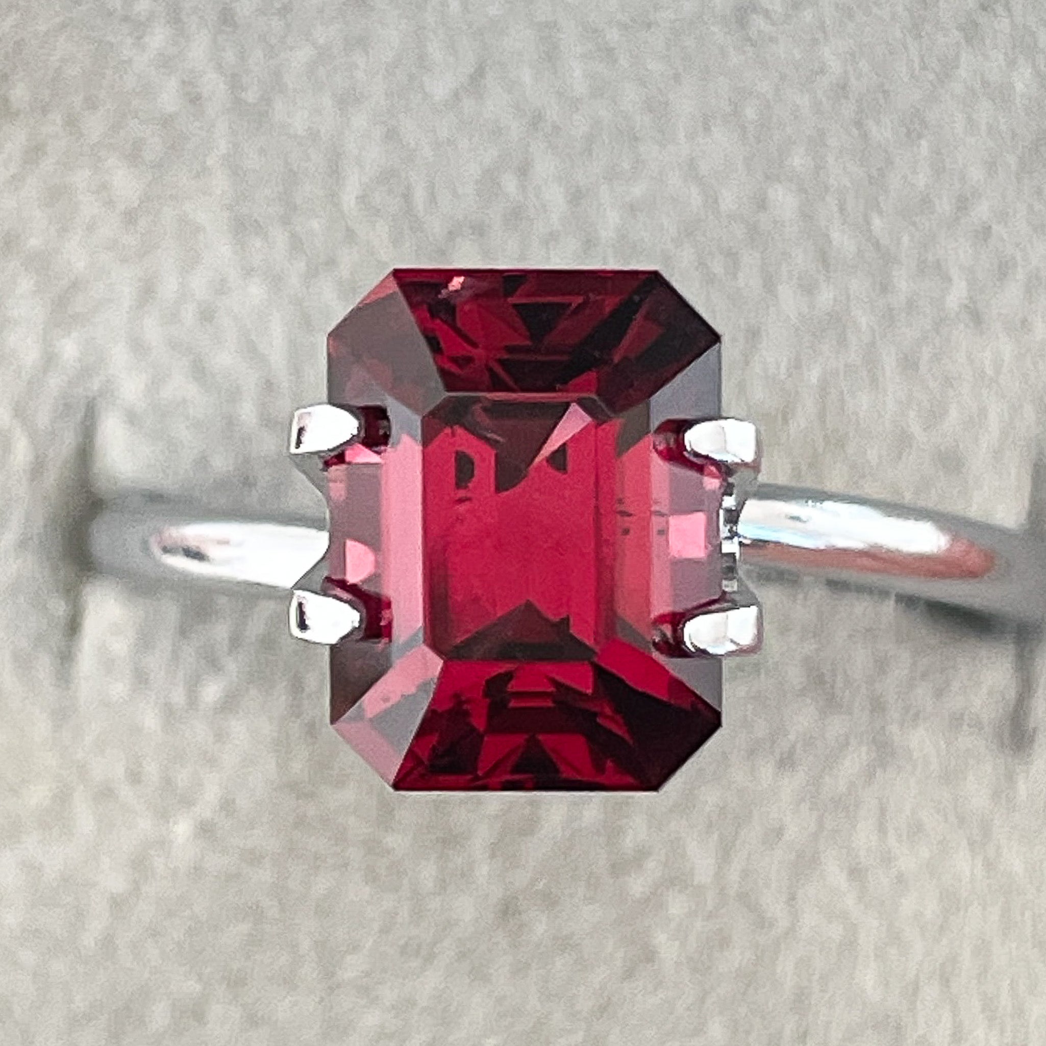 Natural Pyrope Almandite Garnet 3.38 Ct emerald cut loose gemstone with deep red color for jewelry or engagement rings.