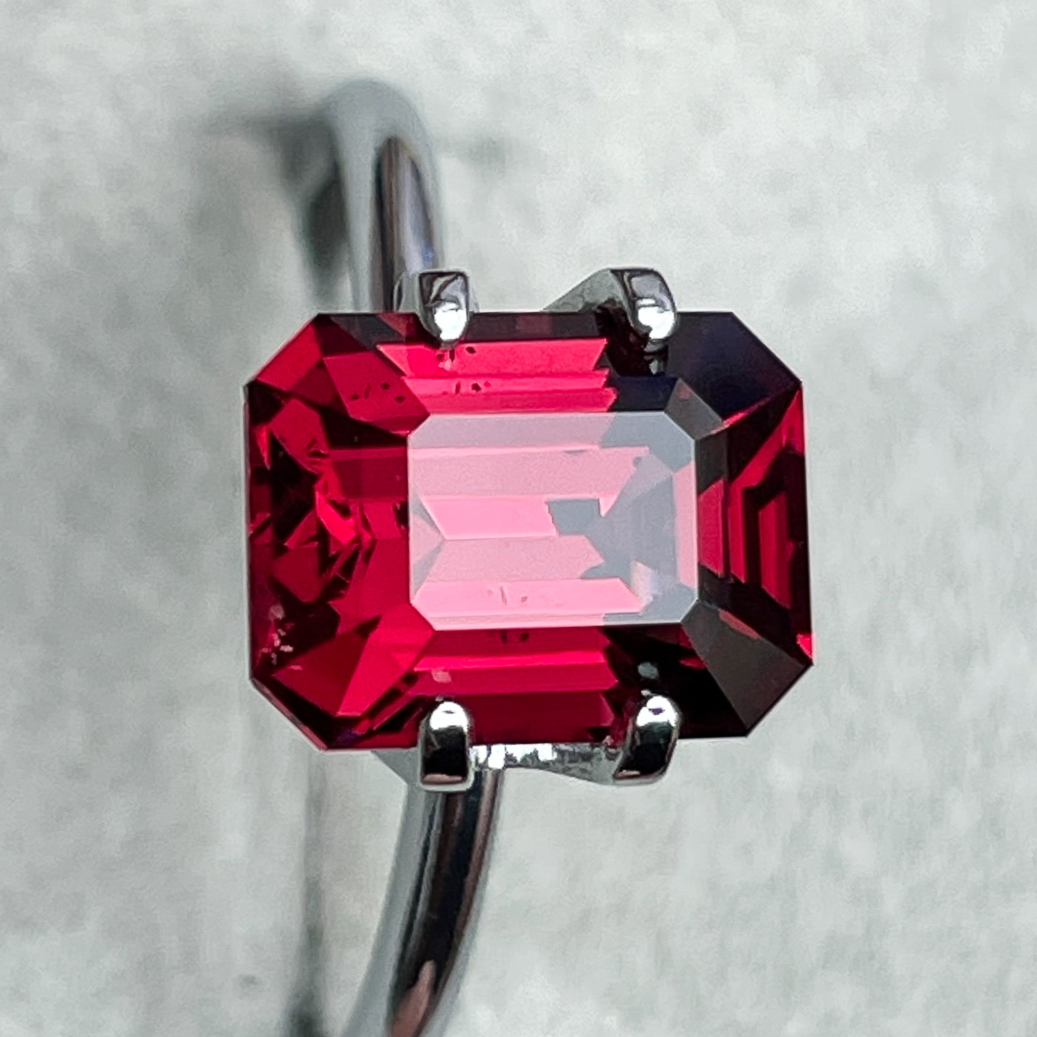 Natural Pyrope Almandite Garnet 3.38 Ct emerald cut loose gemstone with deep red color for jewelry and engagement rings.
