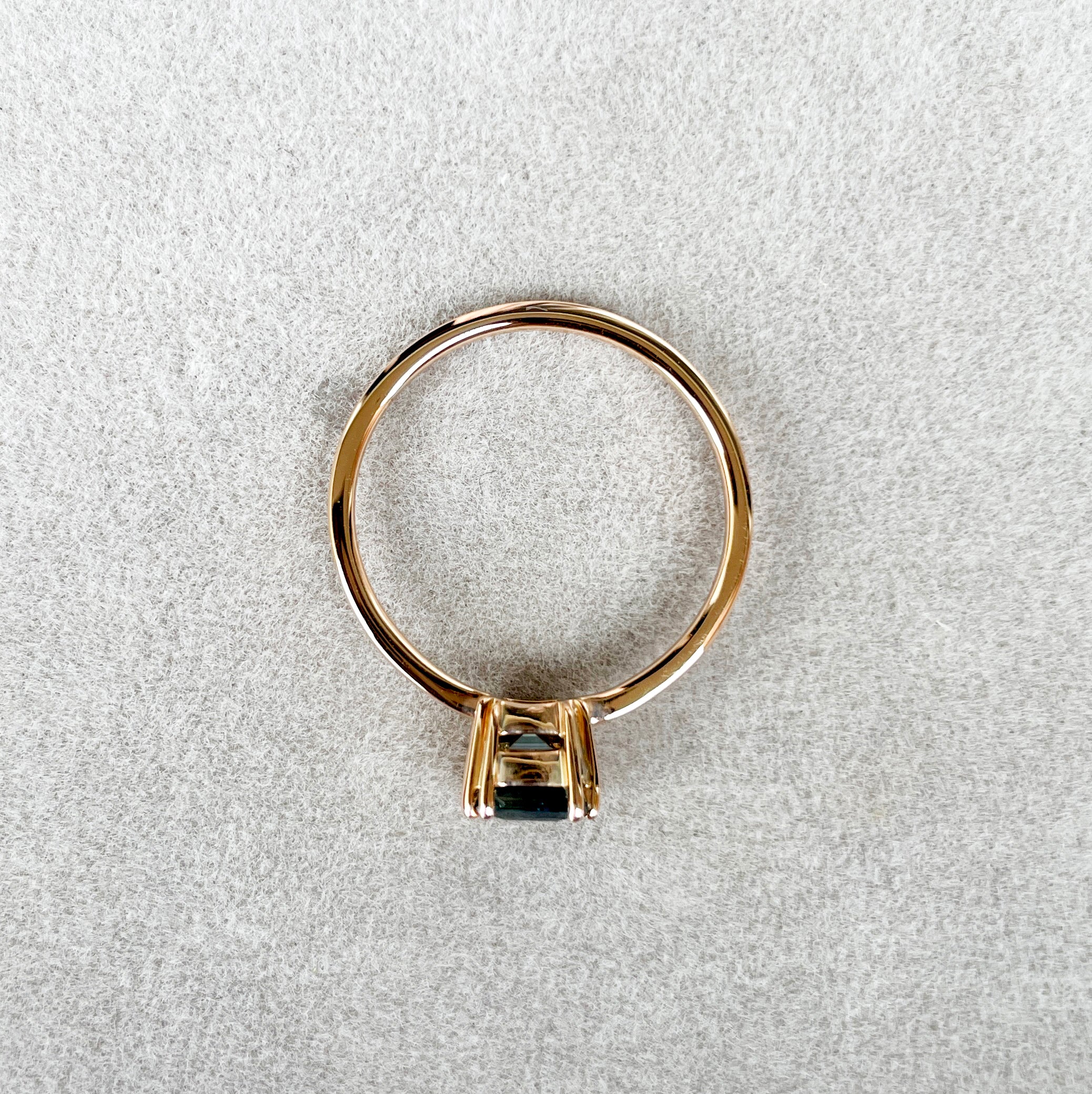 elegant ring features a 1.00 crt  Natural Teal Sapphire surrounded by sparkling CONFLICT-FREE natural white sapphire set in a solid 18k Rose Gold ring setting. The timeless and classic design of this ring will make your engagement unforgettable.