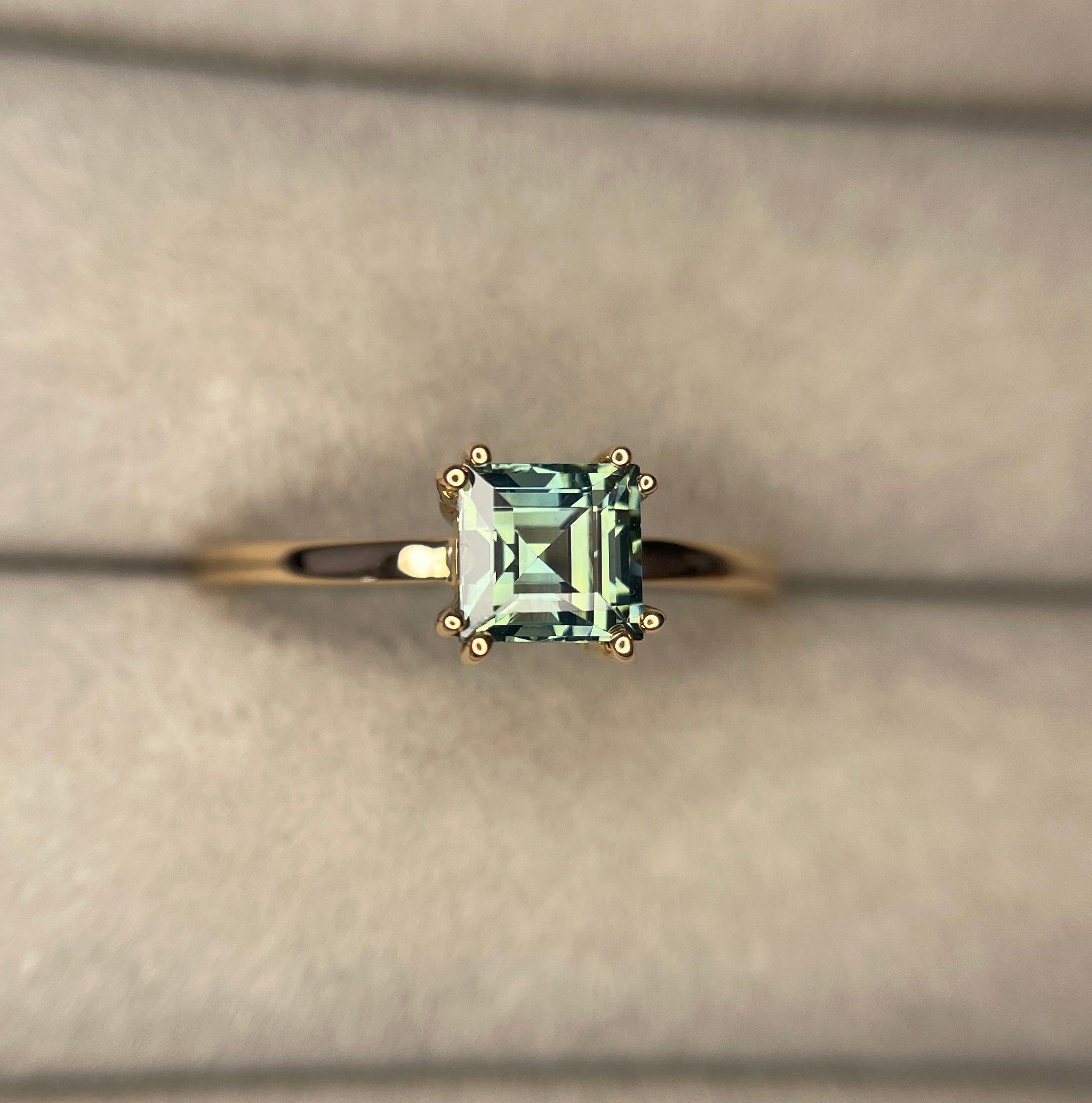 elegant ring features a 1.00 crt  Natural Teal Sapphire surrounded by sparkling CONFLICT-FREE natural white sapphire set in a solid 18k Rose Gold ring setting. The timeless and classic design of this ring will make your engagement unforgettable.
