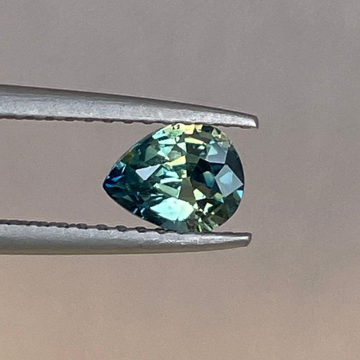 Bi-colored parti sapphire from NASHGEMS, teal green and blue, 0.83 carats, loose precious gemstone for September birthstone jewelry.