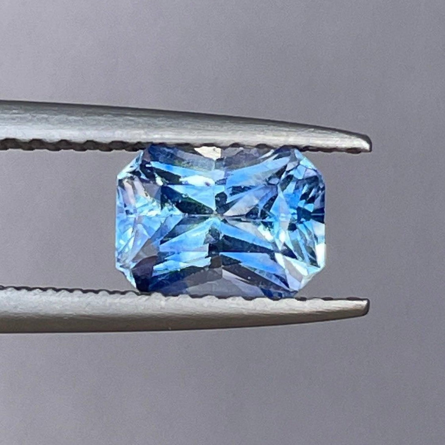 Blue sapphire jewelry including a 1.24 crt natural sapphire engagement ring, pendant, and wedding band by NASHGEMS.