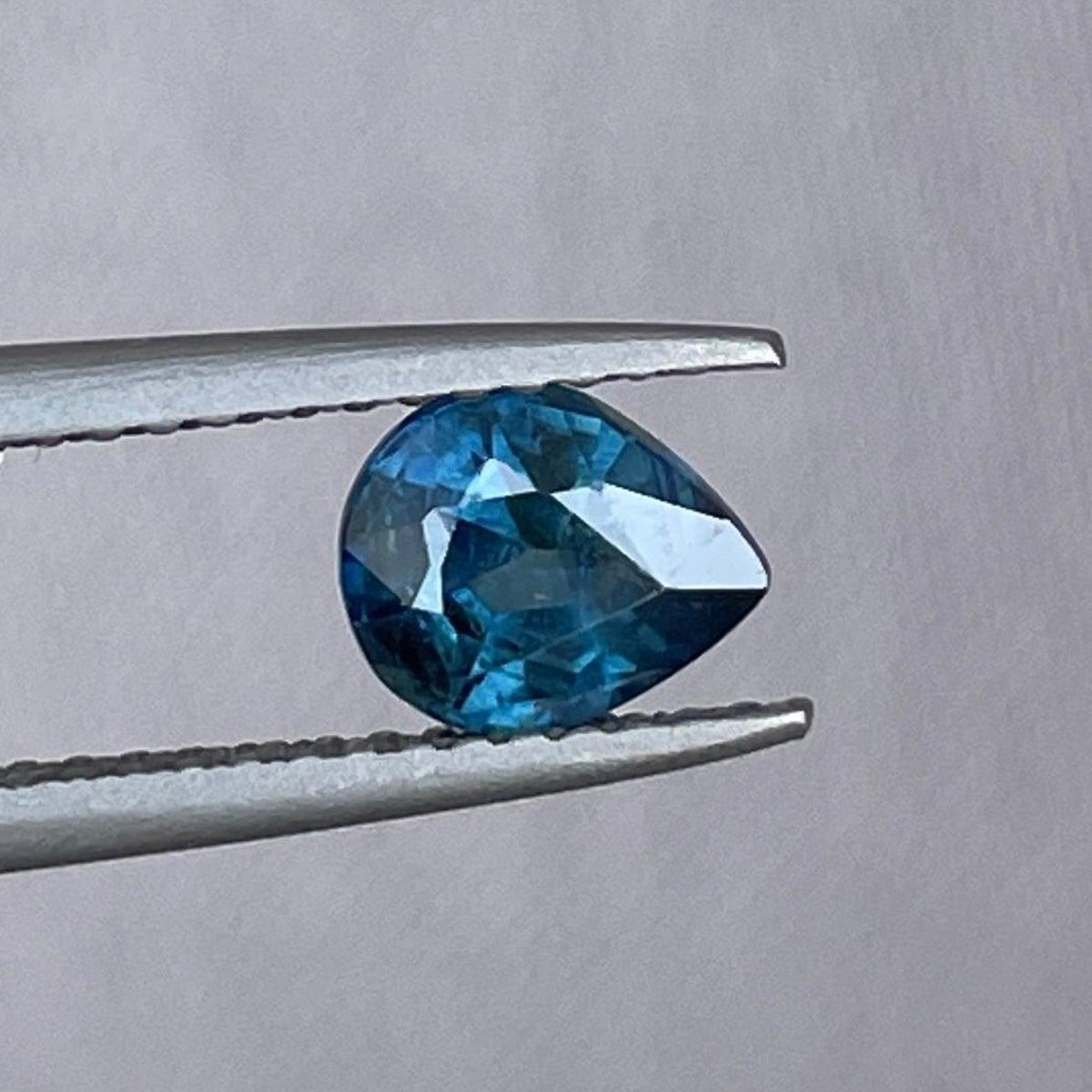 Teal sapphire pear-shaped 1.10 Crt birthstone for September, displayed as a precious stone for engagement rings or necklaces.
