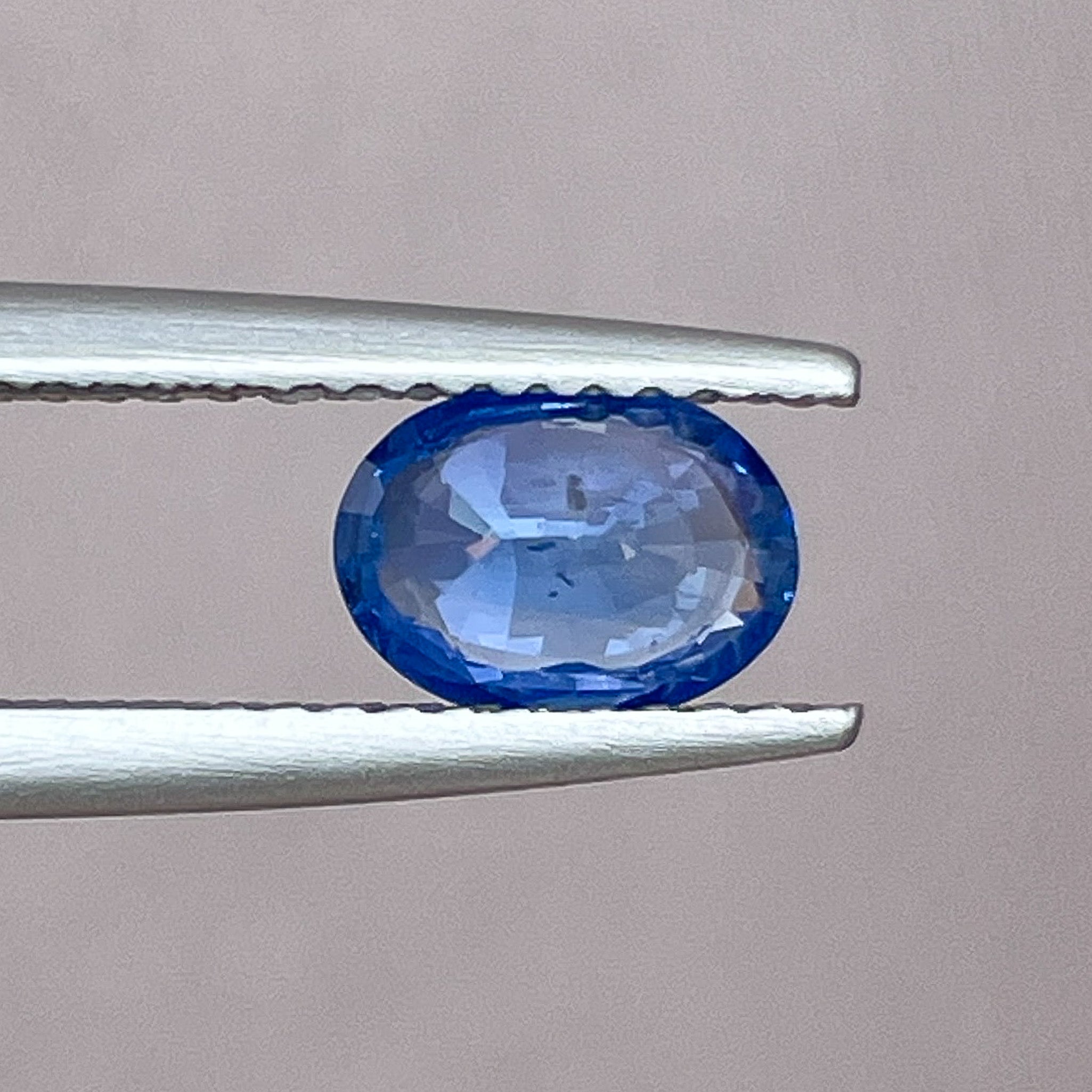 Natural Ceylon blue sapphire 0.97 Ct oval cut loose gemstone by NASHGEMS, showcasing vibrant blue color and polished surface.