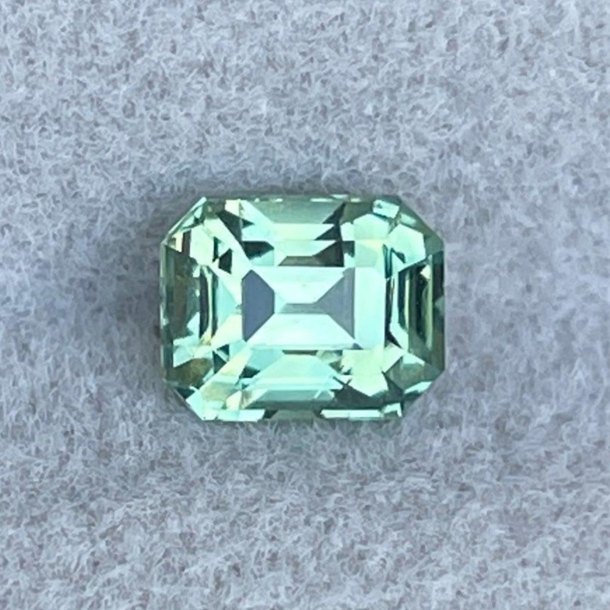 Natural green sapphire gemstone by NASHGEMS, 0.98 ct teal sapphire with emerald cut in pale mint and olive green shades.