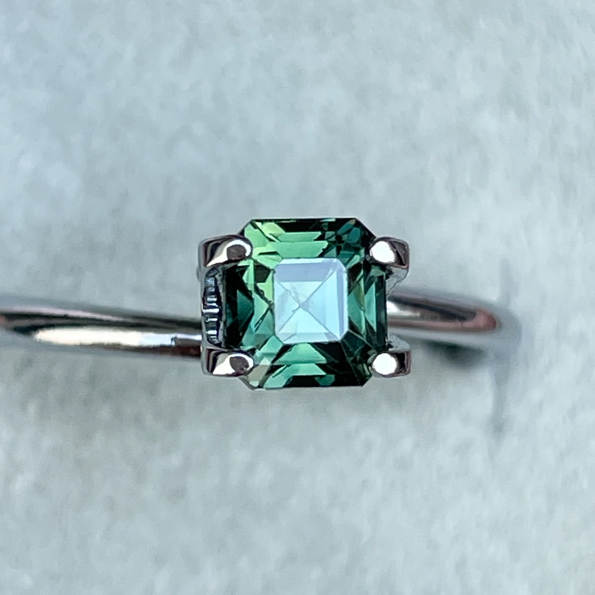 Natural forest green sapphire 1.09 Ct emerald cut loose gemstone from NASHGEMS, perfect for engagement rings or custom jewelry.