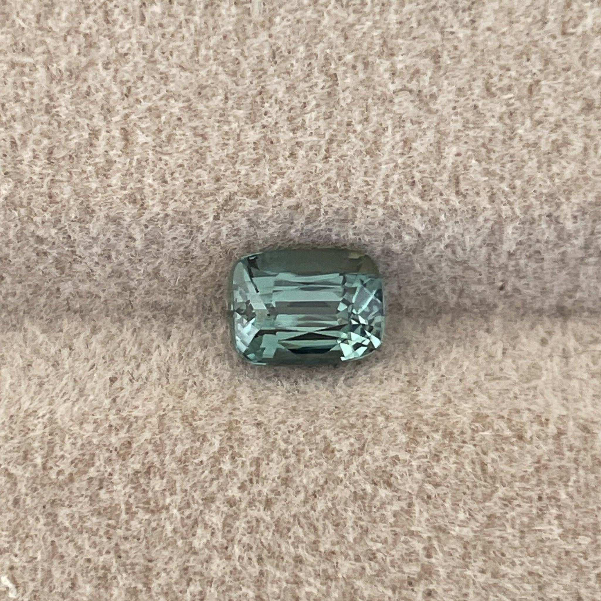 Natural teal green sapphire, 1.03 ct cushion cut, heat treated loose gemstone from NASHGEMS for engagement or custom jewelry.