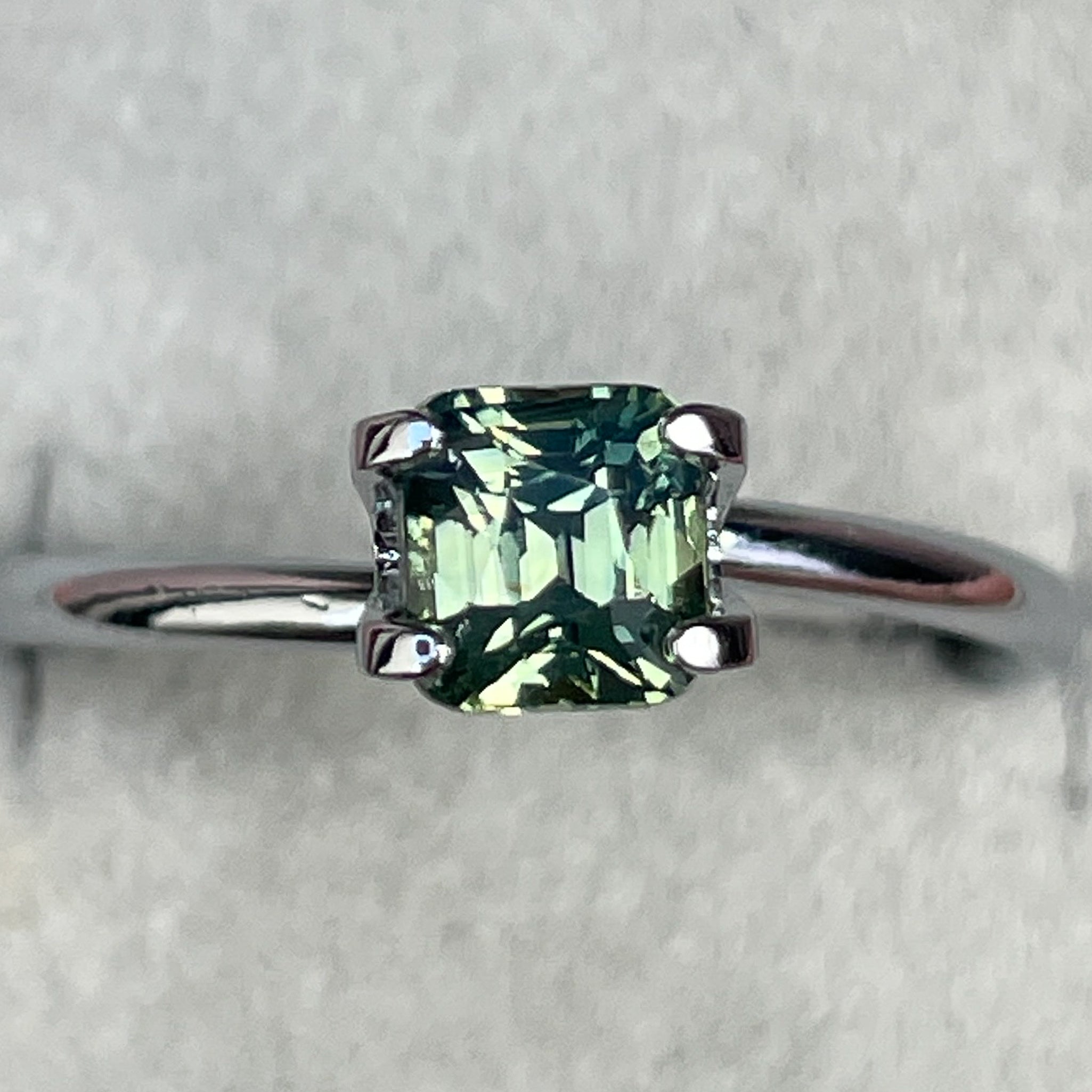 Natural pale green sapphire 1.06 Ct cushion cut from NASHGEMS, loose teal sapphire gemstone ideal for engagement or custom jewelry.