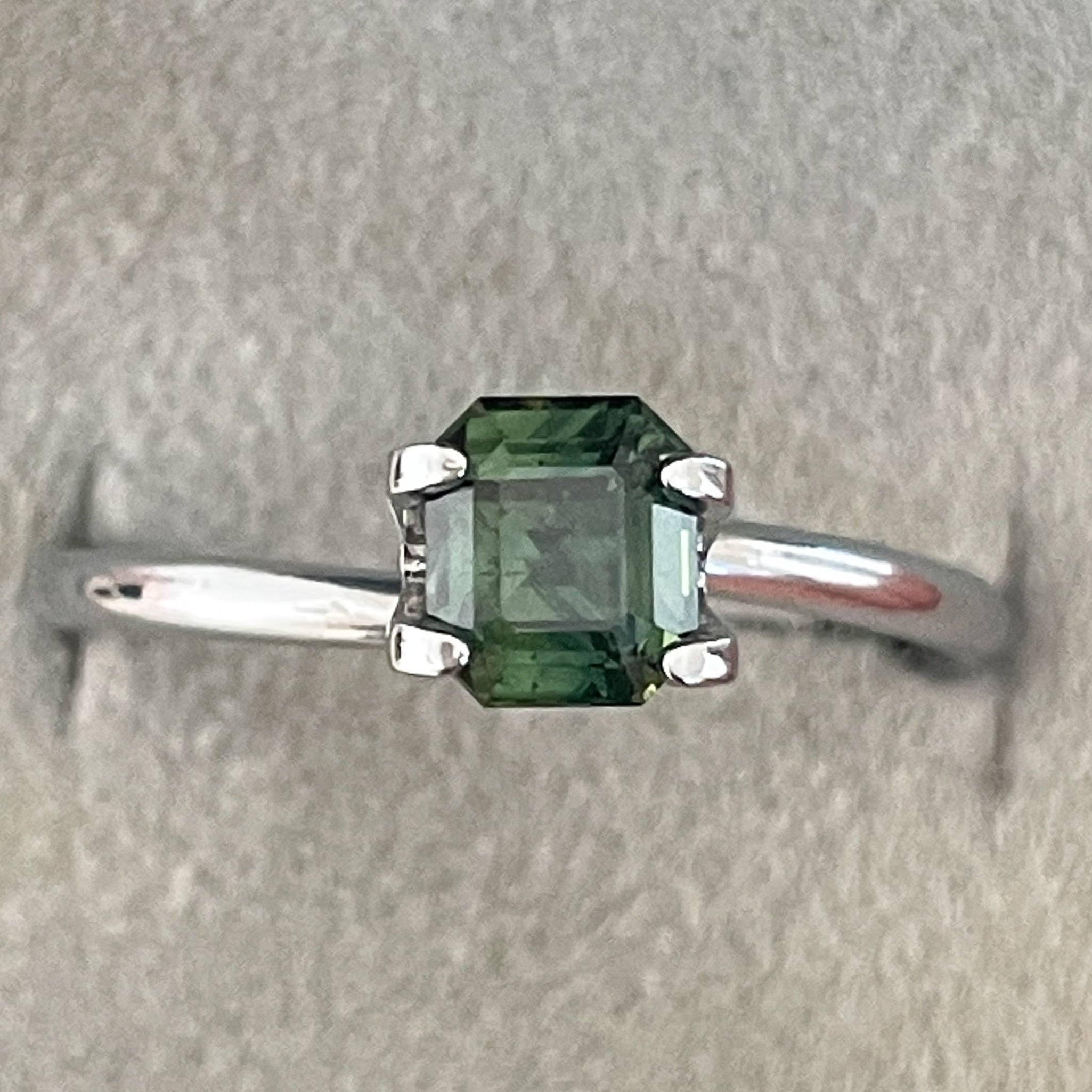 Natural green sapphire 1.04 Ct emerald cut loose gemstone by NASHGEMS, teal-colored sapphire for engagement or custom jewelry.