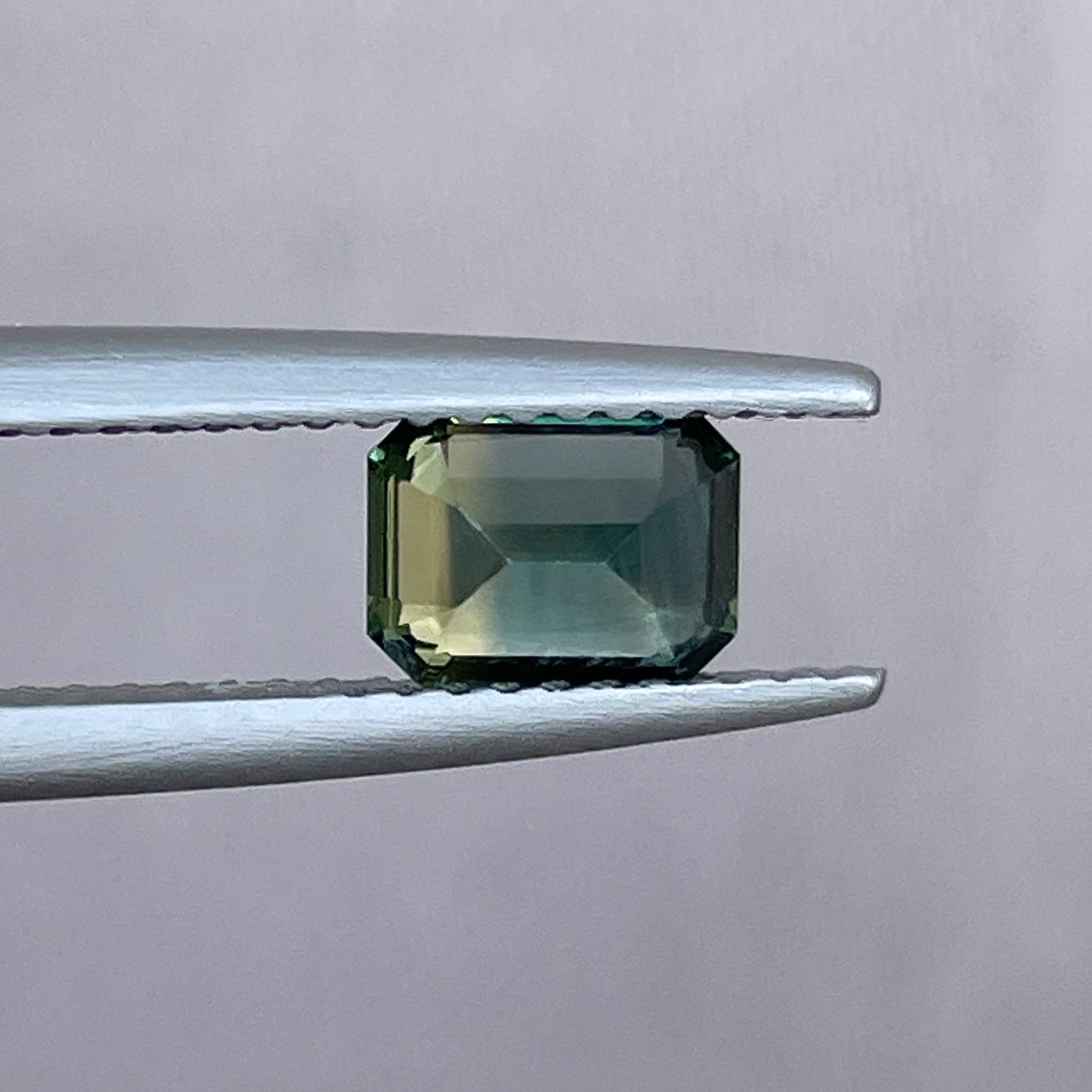 Teal natural bi-color sapphire, 1.13 Ct emerald cut loose gemstone by NASHGEMS, ideal for engagement or custom jewelry.