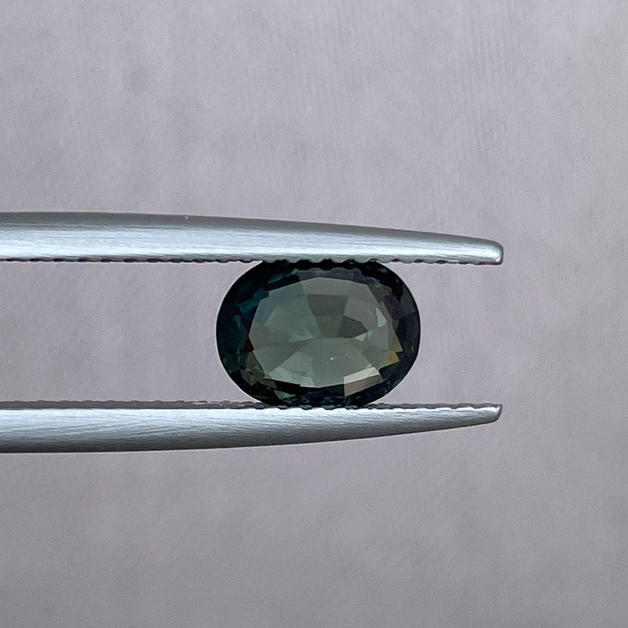 Teal green sapphire loose oval cut 1.52 Ct from NASHGEMS, heat treated gemstone suitable for engagement rings or custom jewelry.