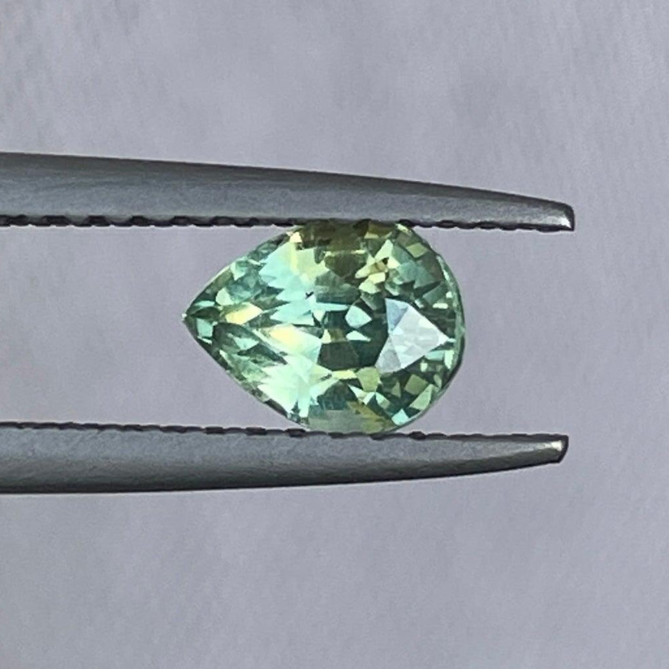 Light green sapphire gemstone pendant featuring a 0.77 ct teal sapphire, ideal for jewelry making, ring setting, or necklace designs.
