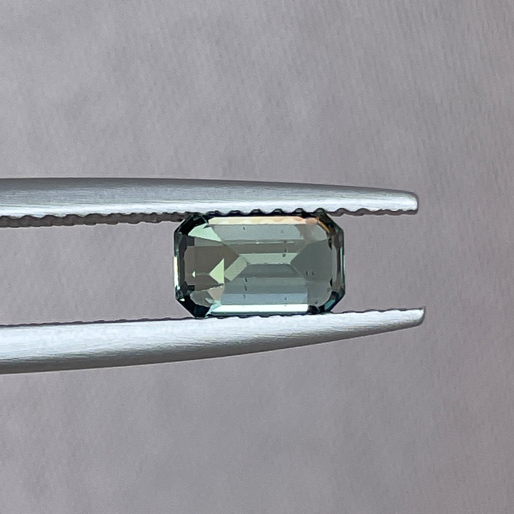 Natural pale green sapphire 1.24 Ct teal emerald cut gemstone by NASHGEMS, perfect for engagement rings or custom jewelry.