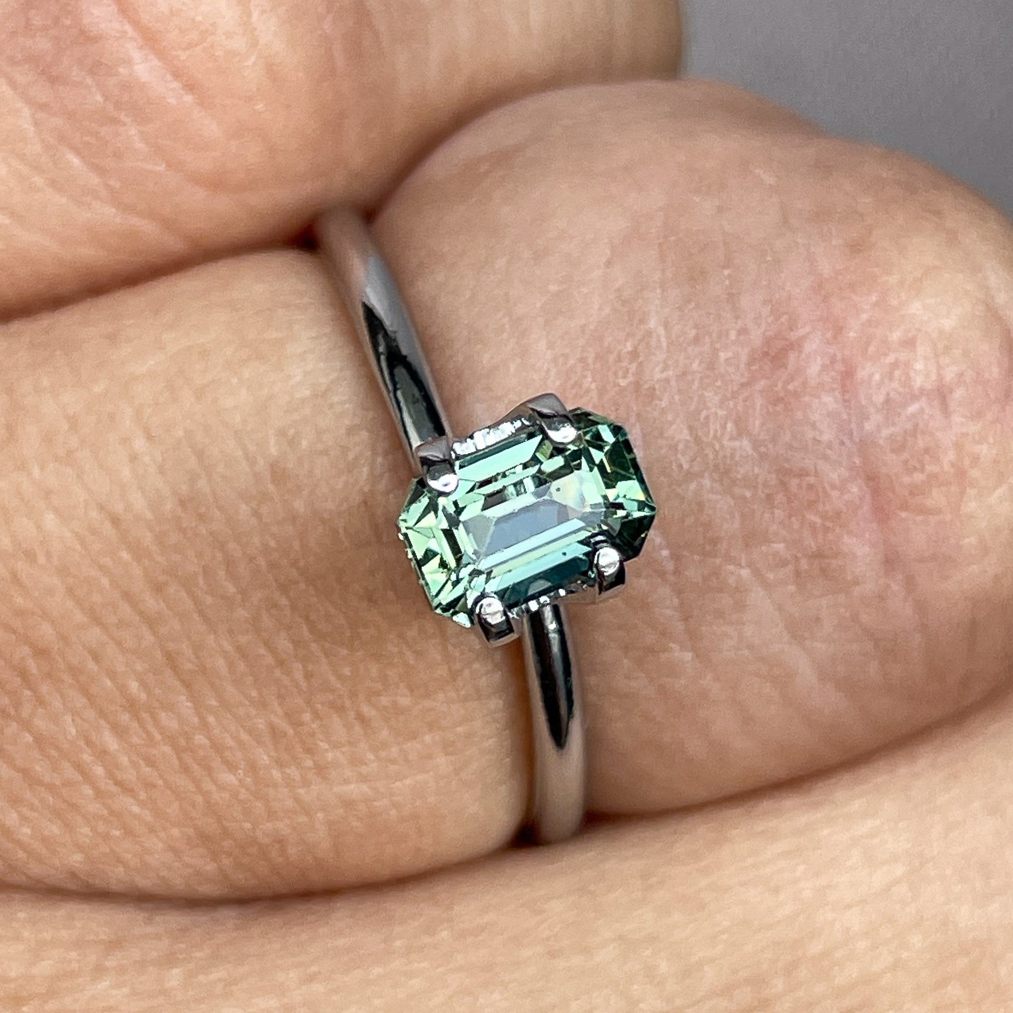 Natural pale green teal sapphire, 1.24 Ct emerald cut loose gemstone by NASHGEMS, ideal for engagement rings or custom jewelry.