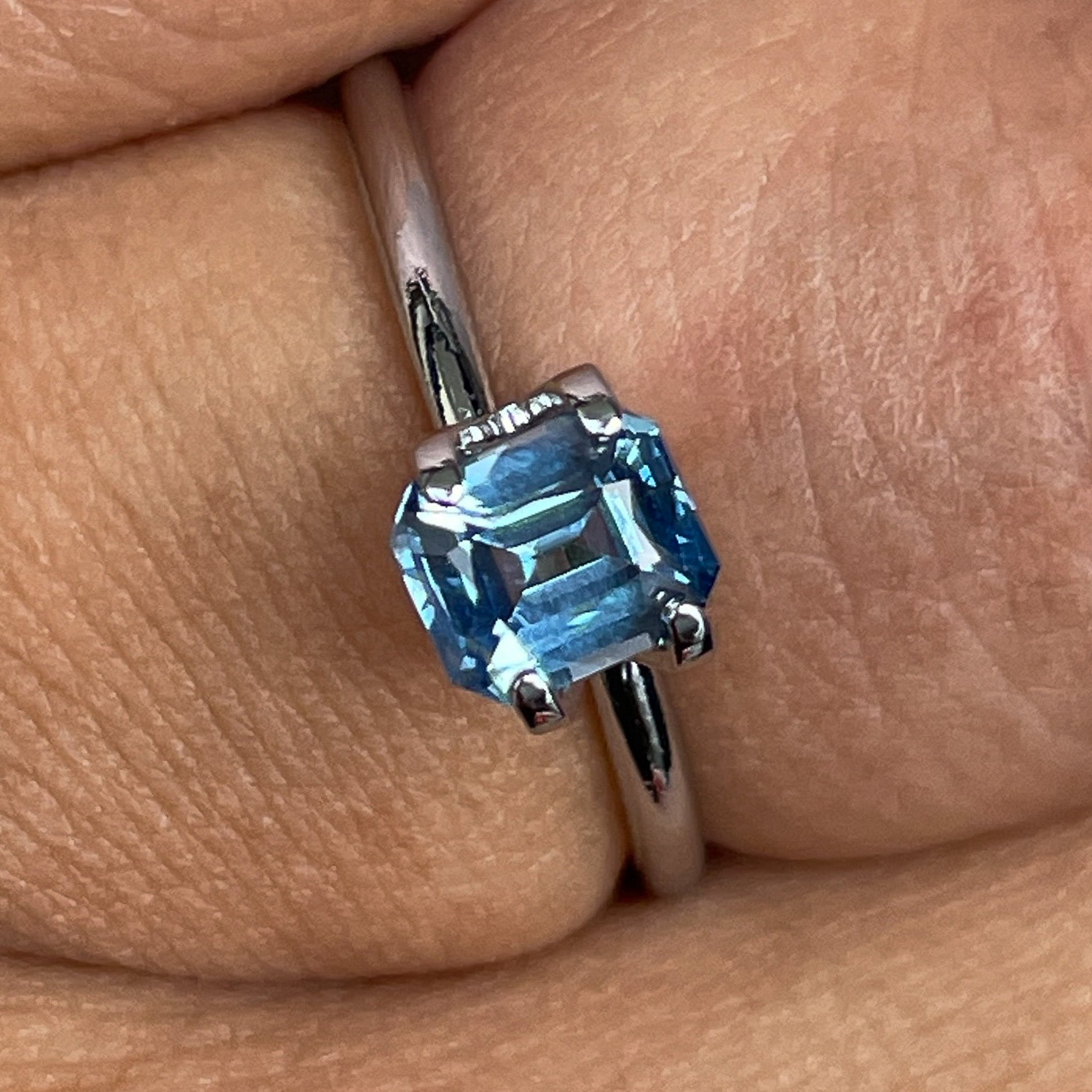 Natural pale blue teal sapphire, 1.08 ct emerald cut loose gemstone by NASHGEMS, ideal for engagement rings or custom jewelry.