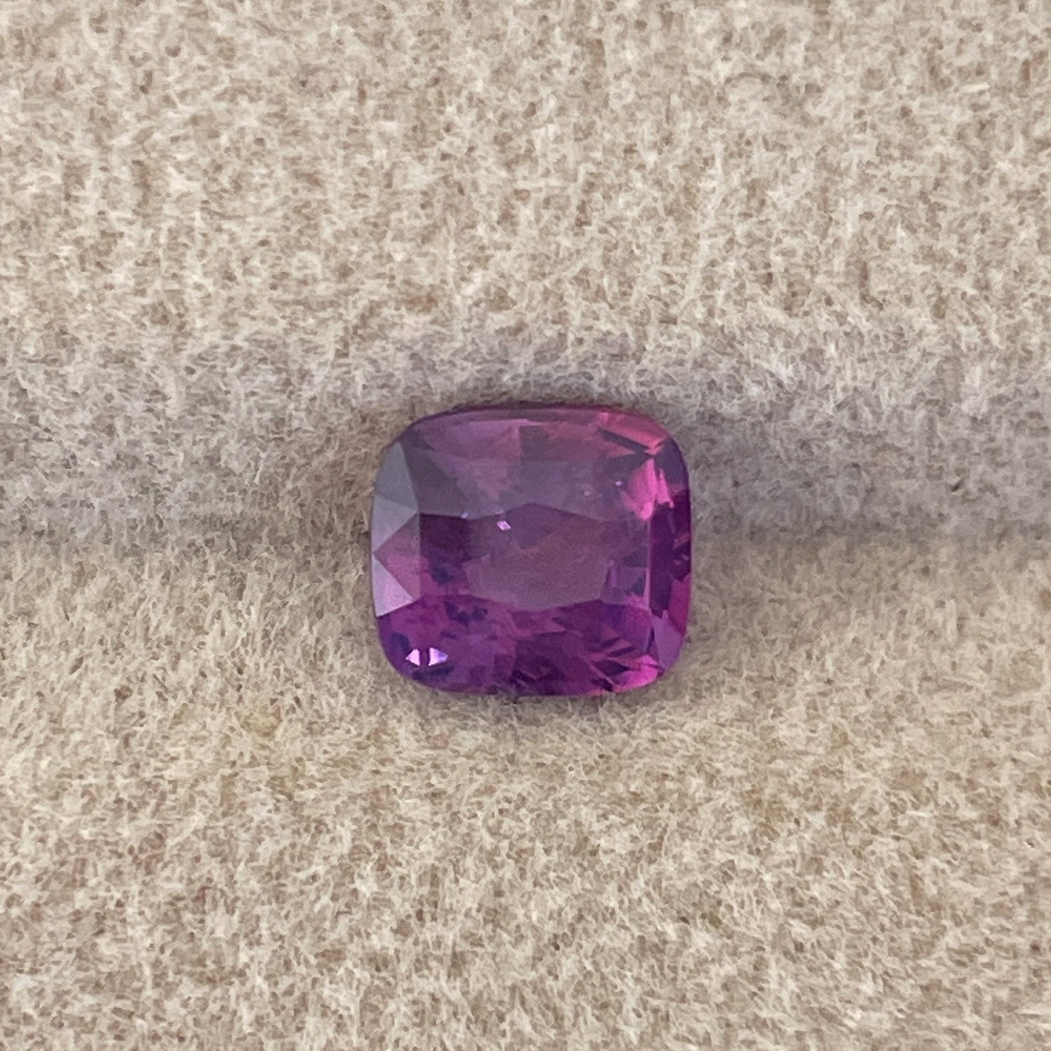 Natural purple sapphire 1.03 Ct cushion cut loose stone by NASHGEMS, showcasing a vibrant pink hue and elegant cushion shape.