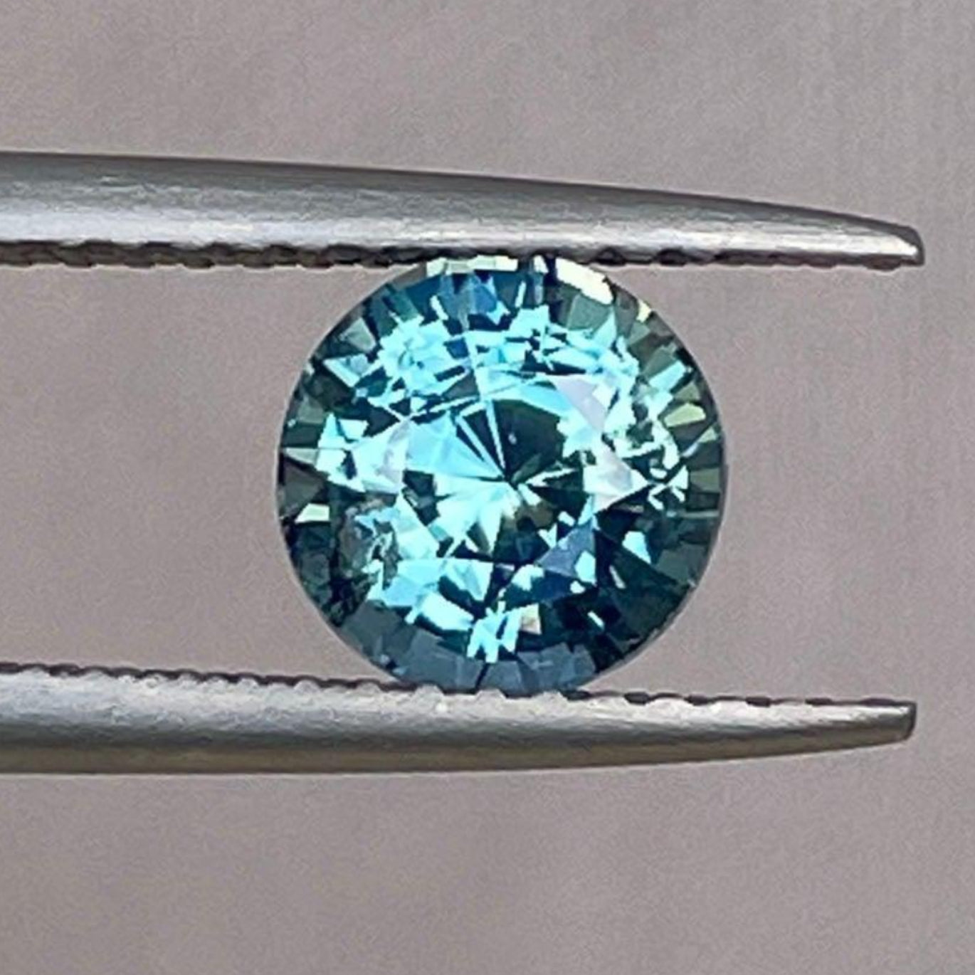 Teal blue green parti sapphire round cut gemstone, 1.55 carats, from NASHGEMS, ideal for engagement rings or pendants.