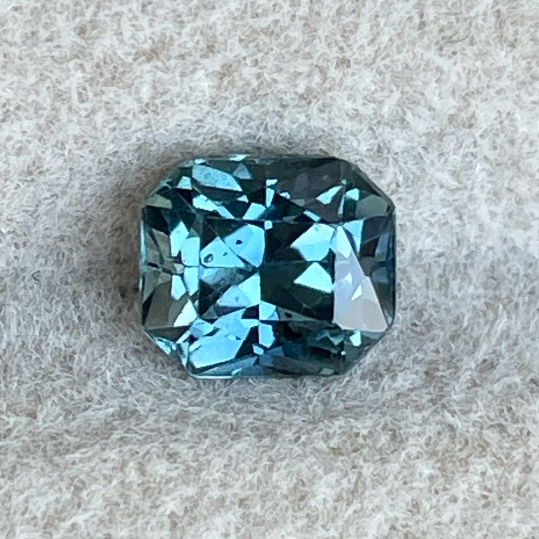 Natural teal blue sapphire 0.98 Ct radiant cut loose gemstone by NASHGEMS, perfect for engagement rings or custom jewelry.