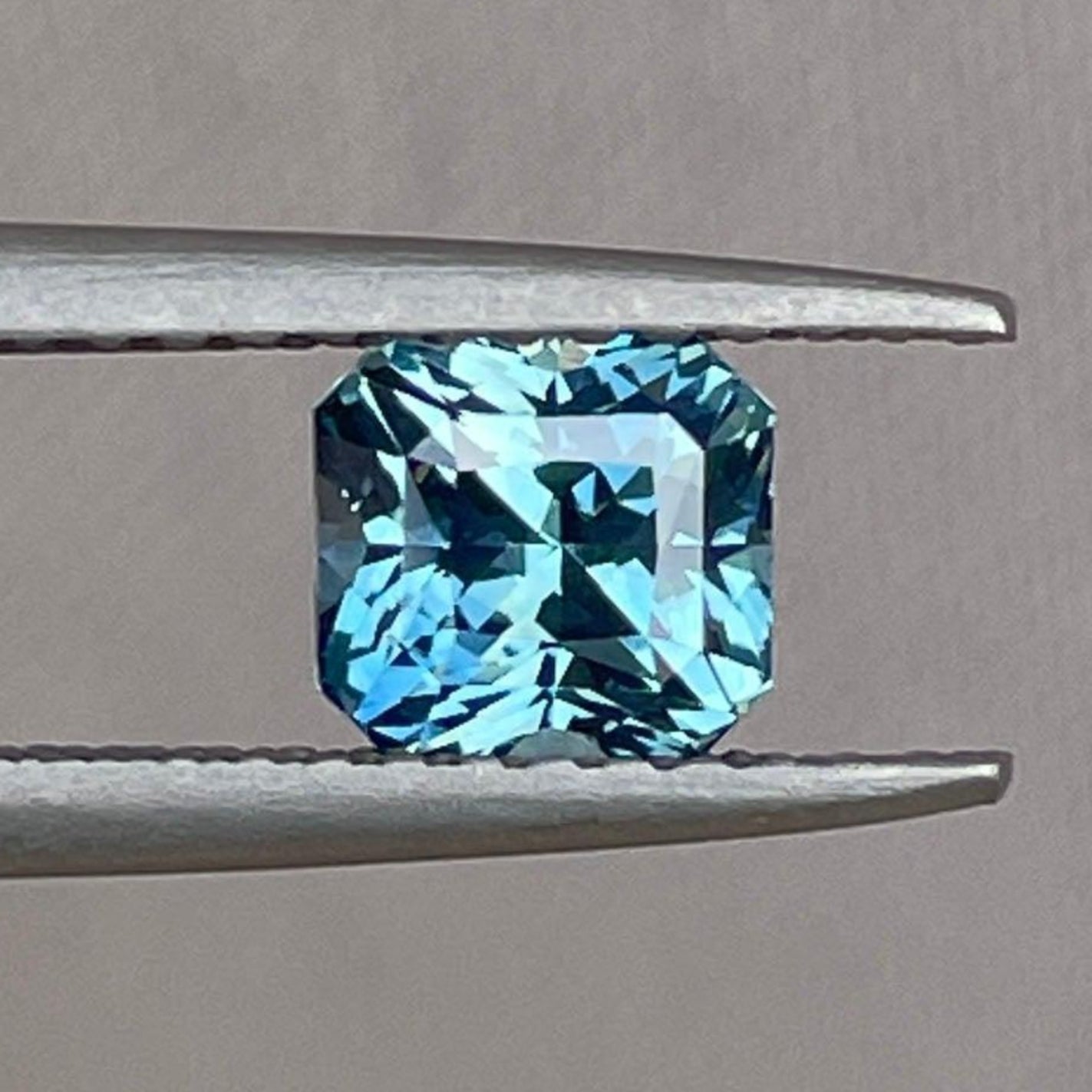 Teal sapphire loose gemstone, radiant cut, 1.14 carats, blue-green September birthstone, from NASHGEMS, ideal for jewelry settings.