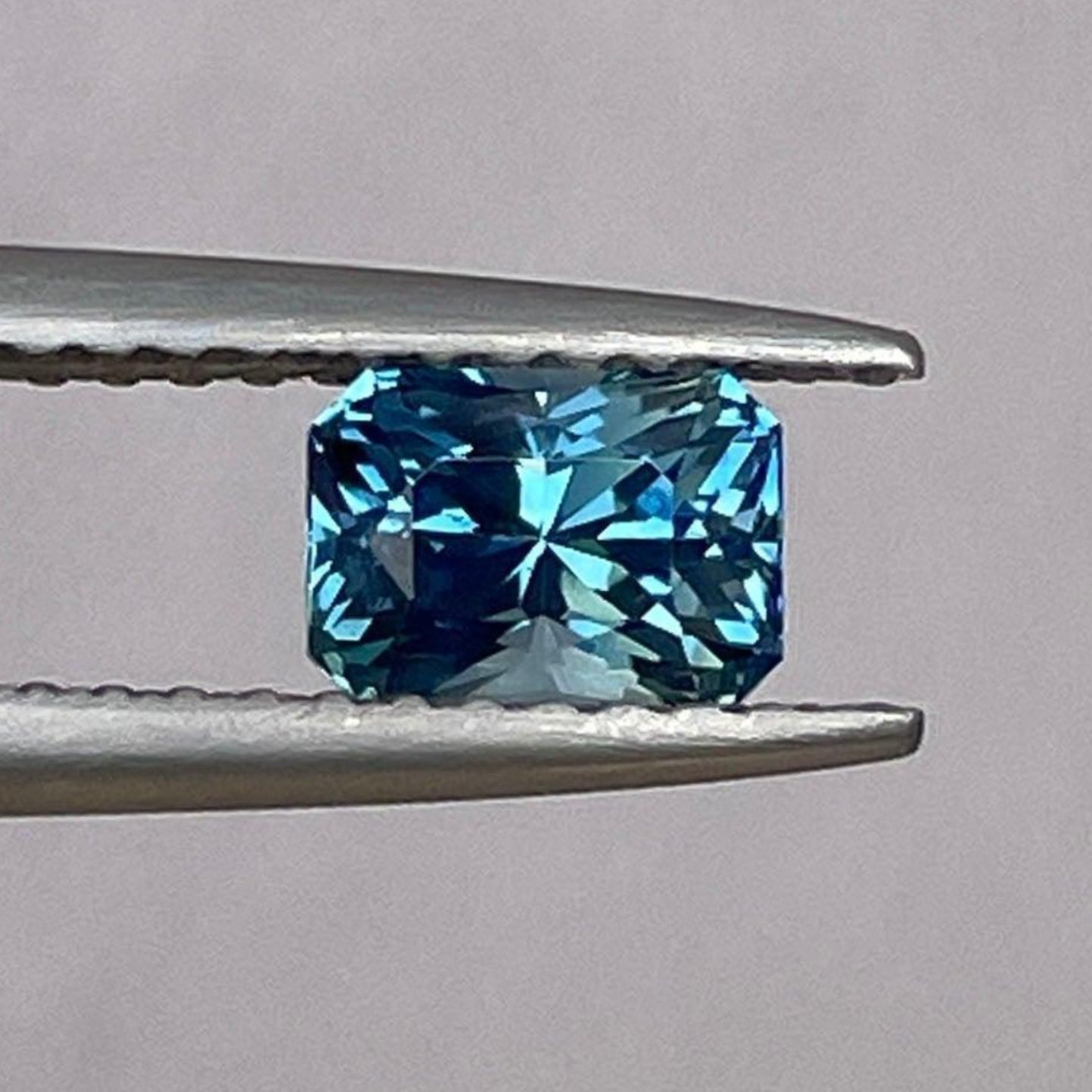 Bluish-green sapphire September birthstone, 0.92 ct radiant cut, loose teal sapphire from NASHGEMS for jewelry setting.