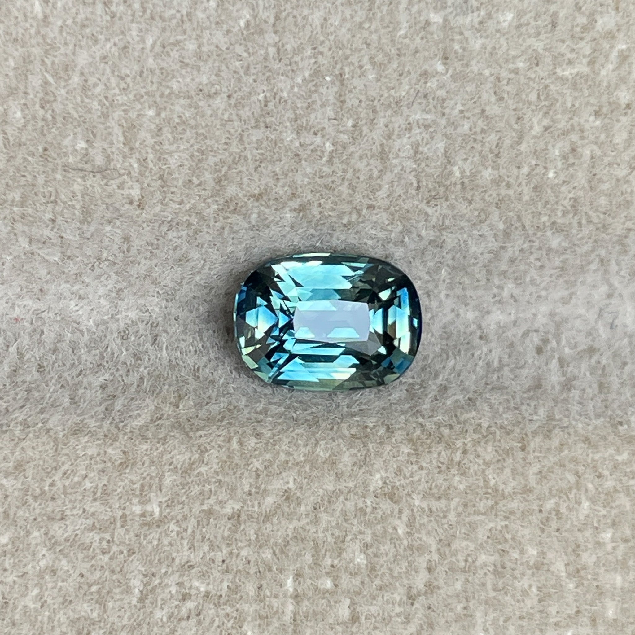 Natural teal sapphire 1.36 Ct cushion cut loose gemstone by NASHGEMS, ideal for engagement rings or custom jewelry.