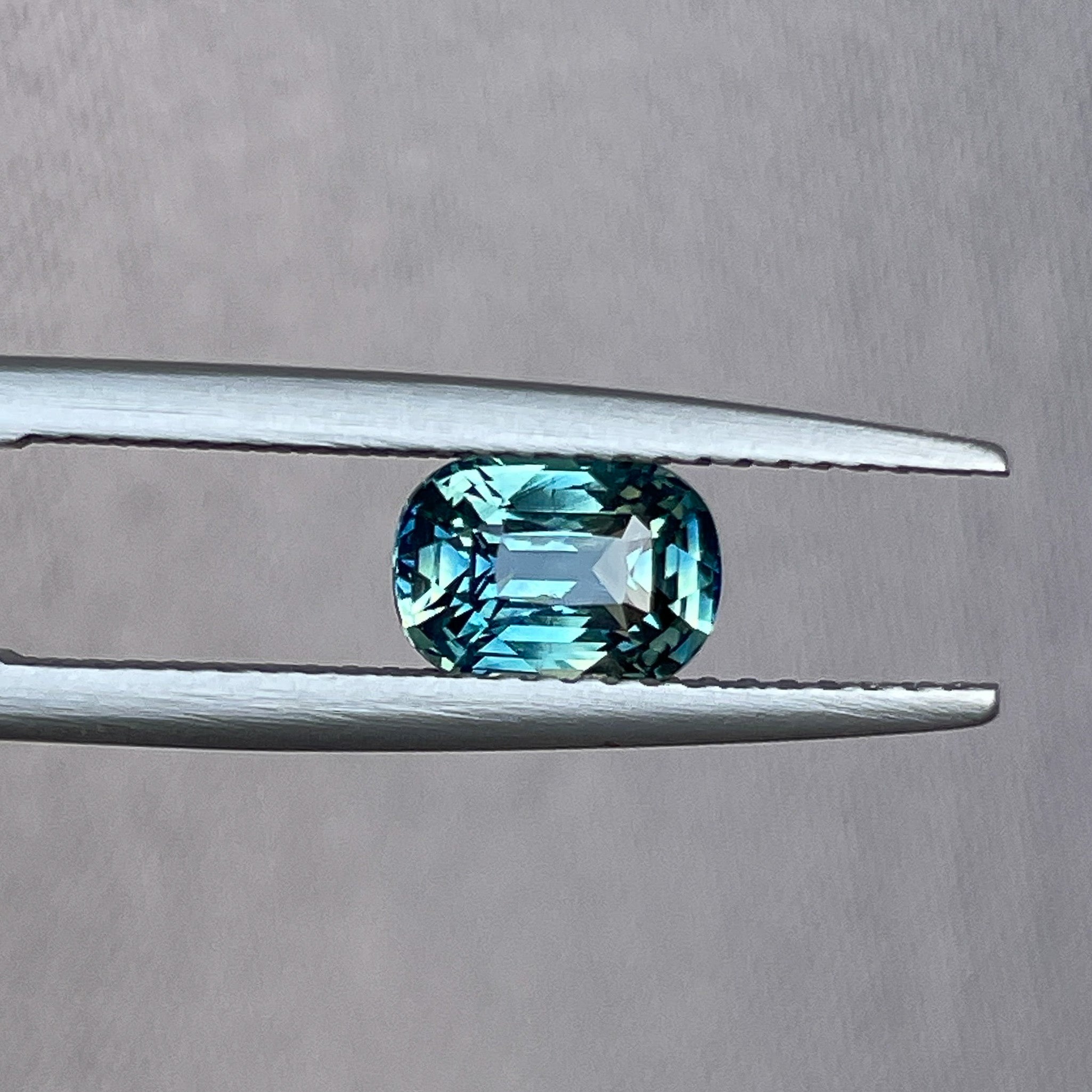 Natural teal sapphire 1.36 Ct cushion cut loose gemstone by NASHGEMS, perfect for engagement rings or custom jewelry.