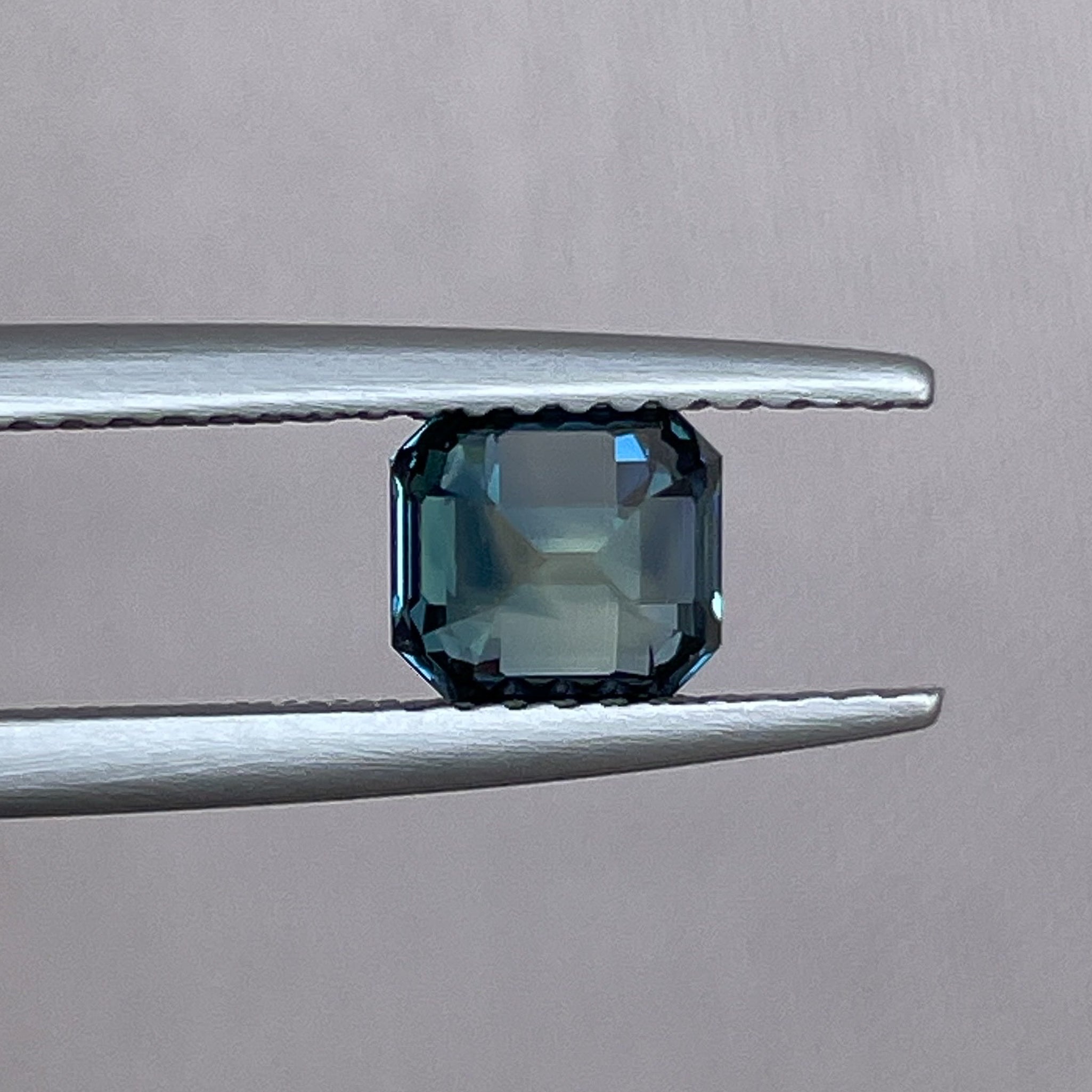 Natural teal green sapphire, 1.36 Ct emerald cut, loose gemstone from NASHGEMS, ideal for engagement rings or custom jewelry.