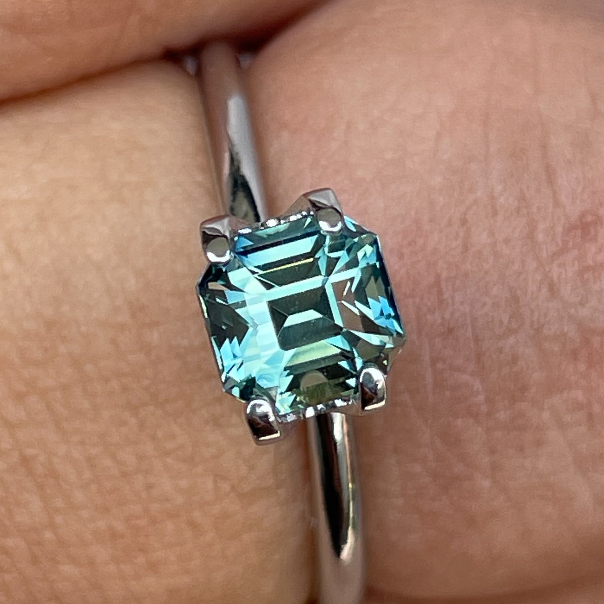 Teal green sapphire 1.36 Ct emerald cut, loose gemstone by NASHGEMS, ideal for engagement rings or custom jewelry designs.