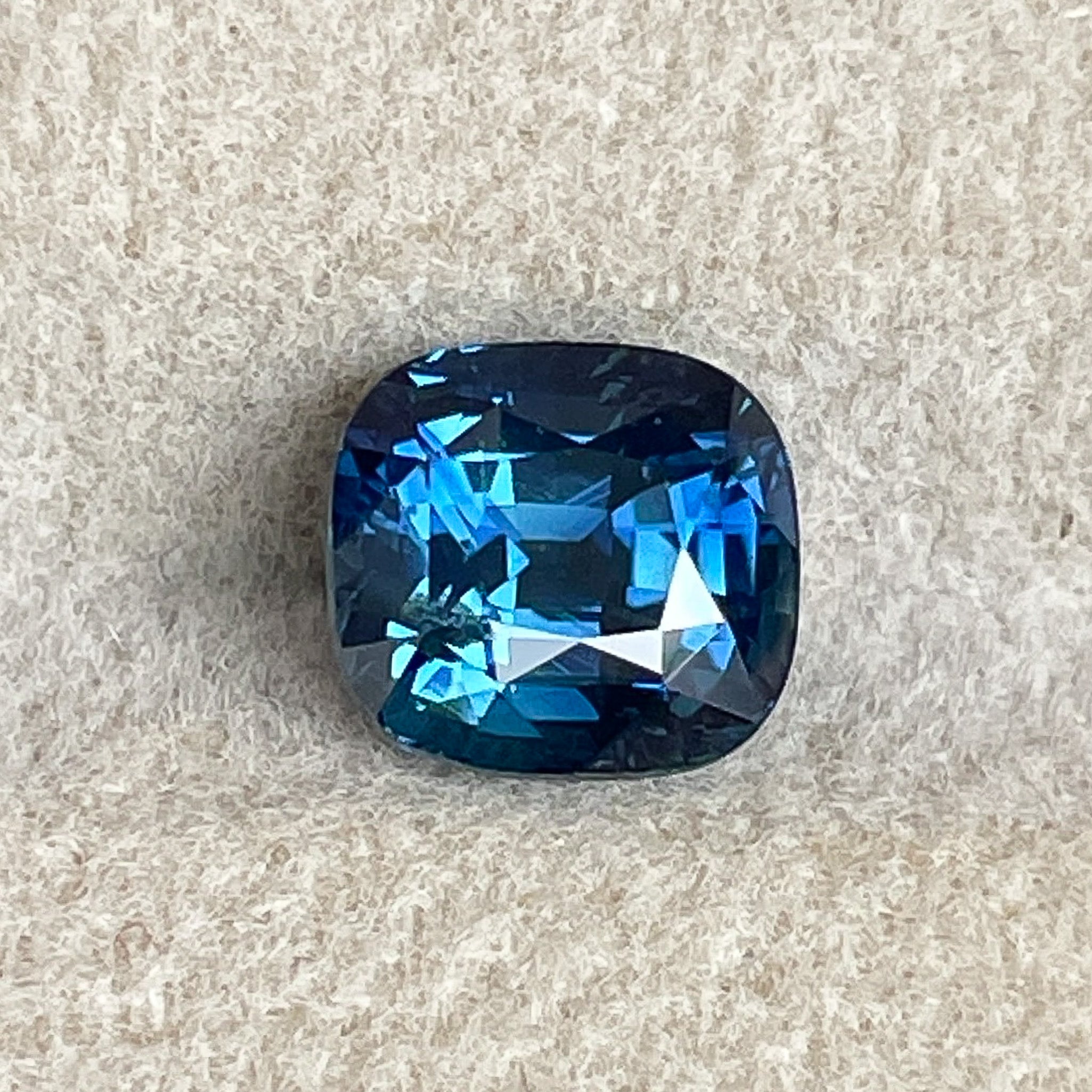 Natural teal blue sapphire, 2.07 ct cushion cut loose gemstone from NASHGEMS, ideal for engagement rings or custom jewelry.