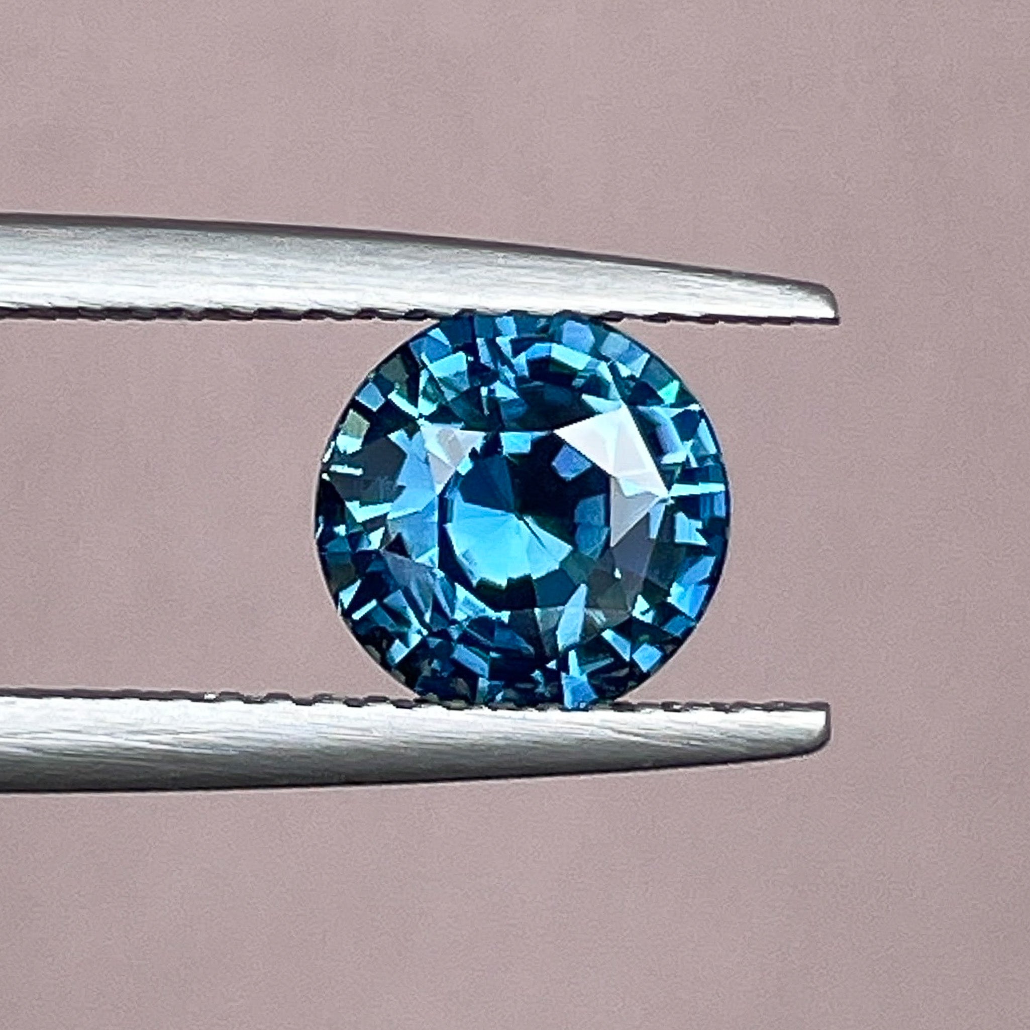 Natural teal blue sapphire, 2.10 Ct round cut loose gemstone by NASHGEMS, ideal for engagement rings or custom jewelry.