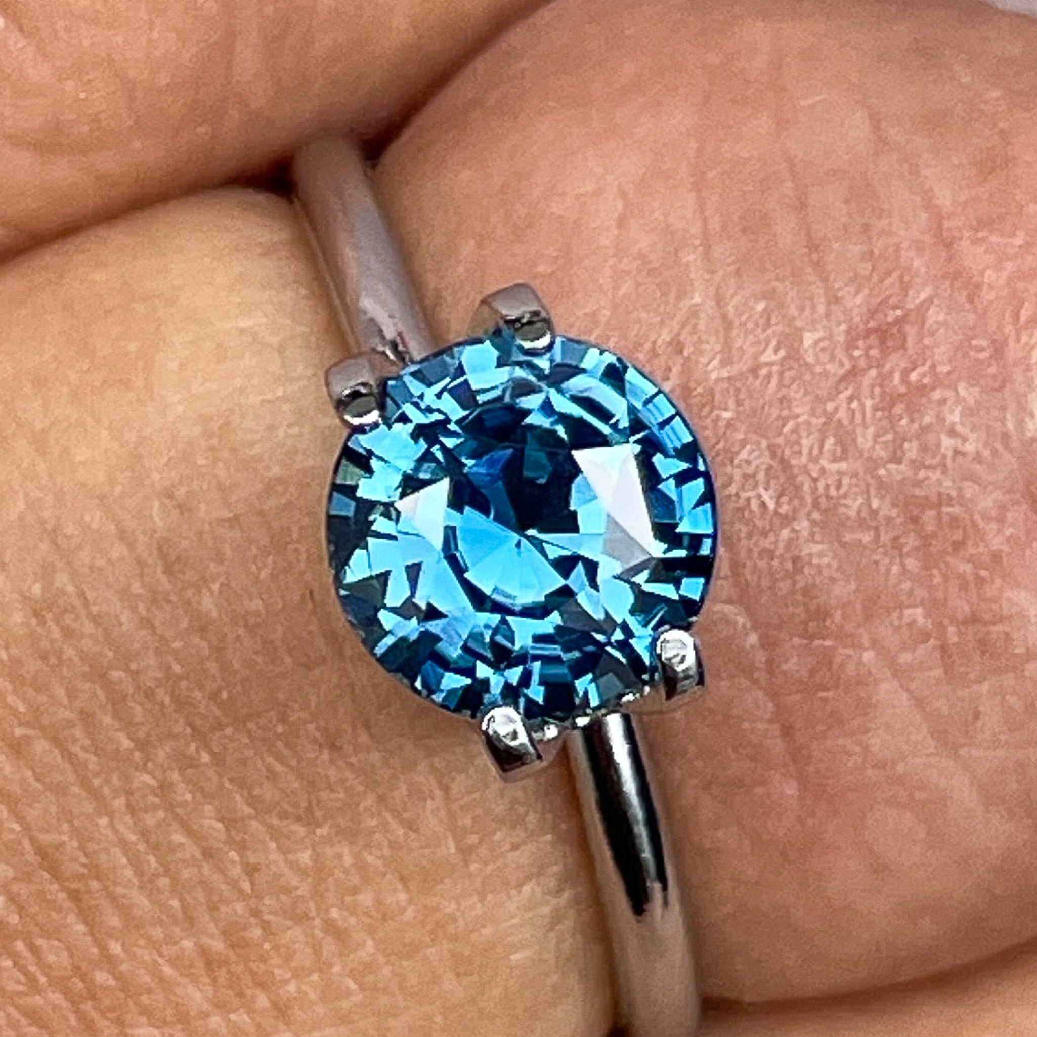 Natural teal blue sapphire, 2.10 ct round cut loose gemstone by NASHGEMS, ideal for engagement rings or custom jewelry.