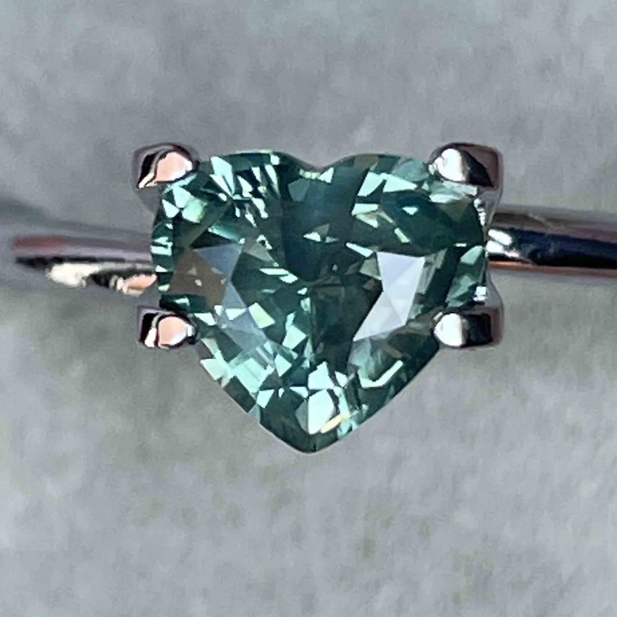 Teal green sapphire heart-shaped loose gemstone, 1.12ct, heat-treated natural sapphire from NASHGEMS for jewelry or engagement.