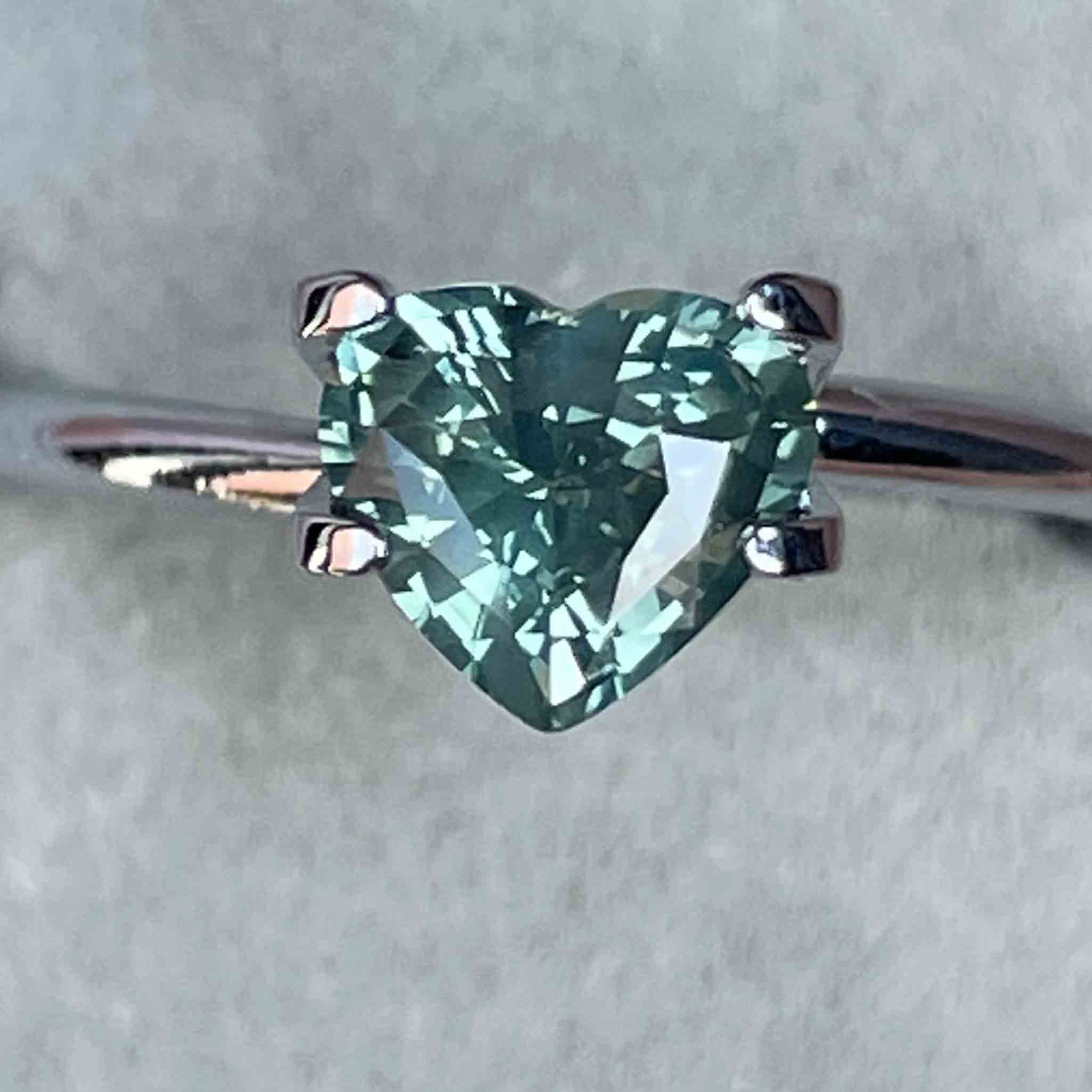 Teal green sapphire heart-shaped loose gemstone, 1.12 carats, heat-treated natural sapphire by NASHGEMS for jewelry making.