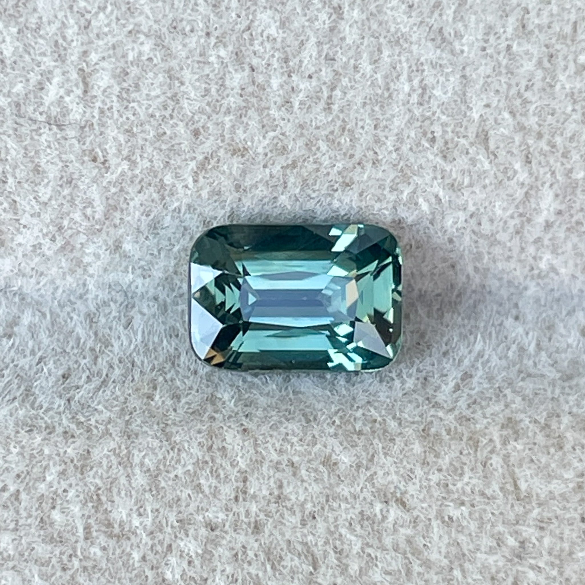 Natural pale green teal sapphire, 1.14 Ct cushion cut loose gemstone by NASHGEMS, suitable for engagement rings or custom jewelry.