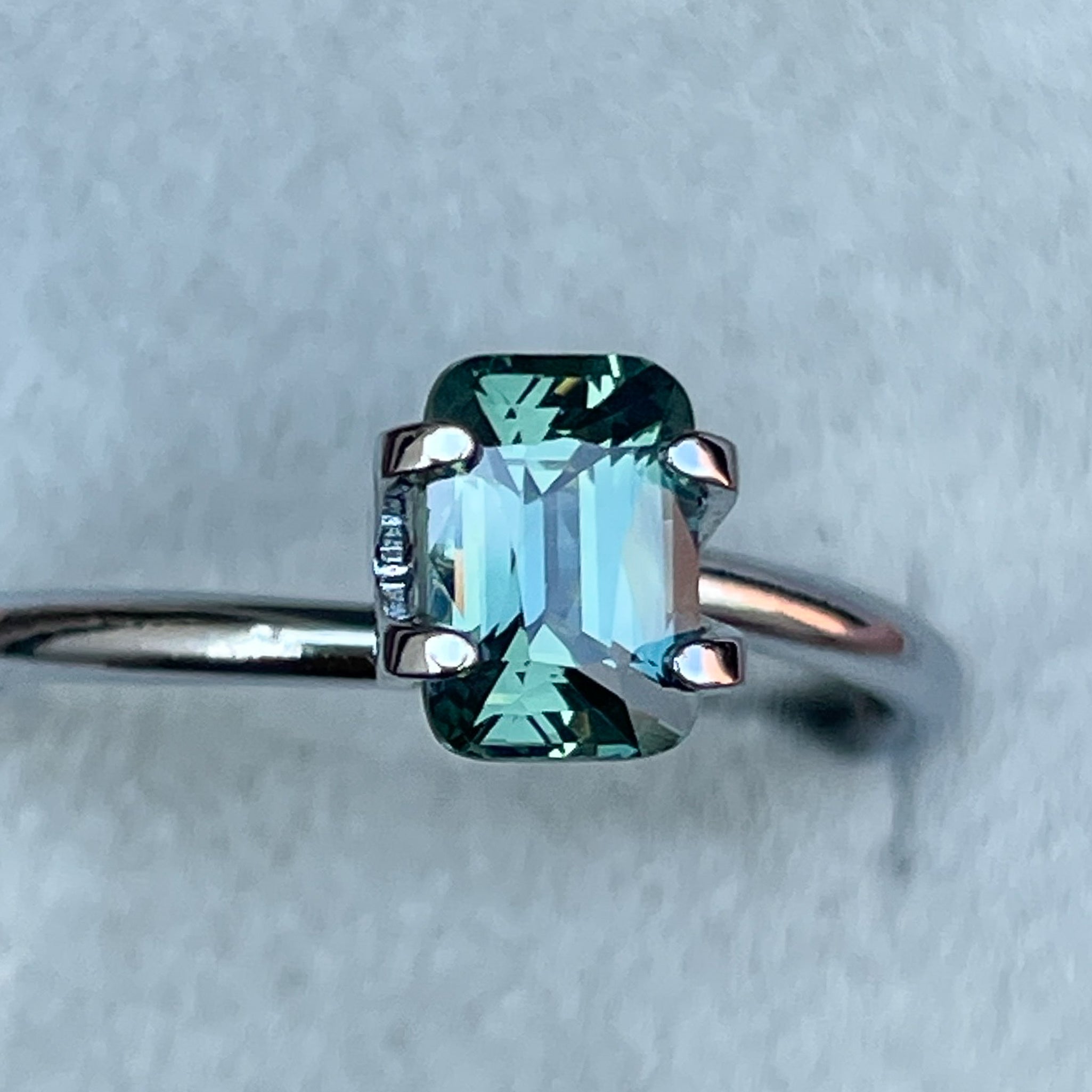 Natural pale green teal sapphire, 1.14 Ct cushion cut loose gemstone by NASHGEMS, suitable for engagement or custom jewelry.