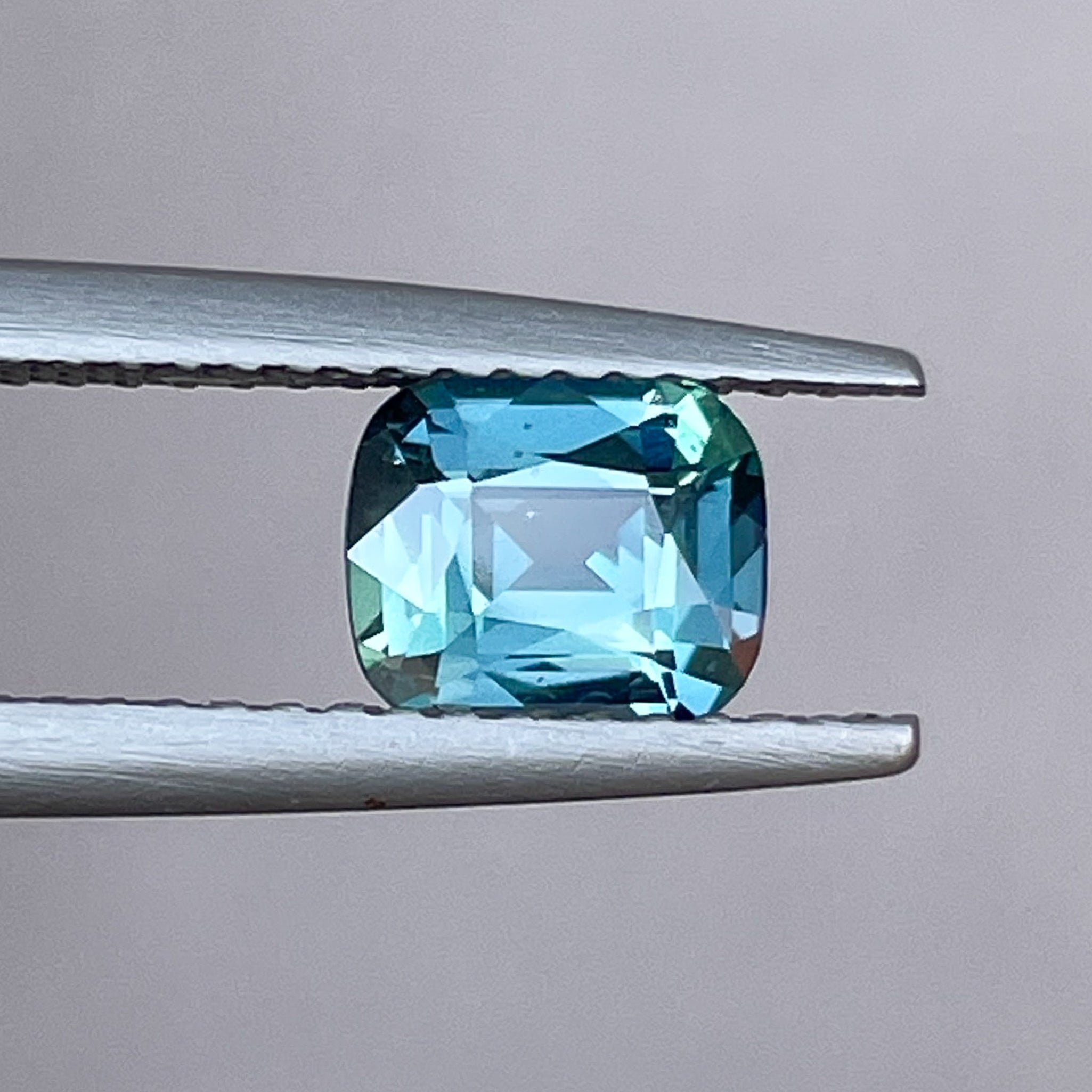Natural teal blue sapphire 1.18 Ct cushion cut loose gemstone from NASHGEMS, ideal for engagement rings or custom jewelry.