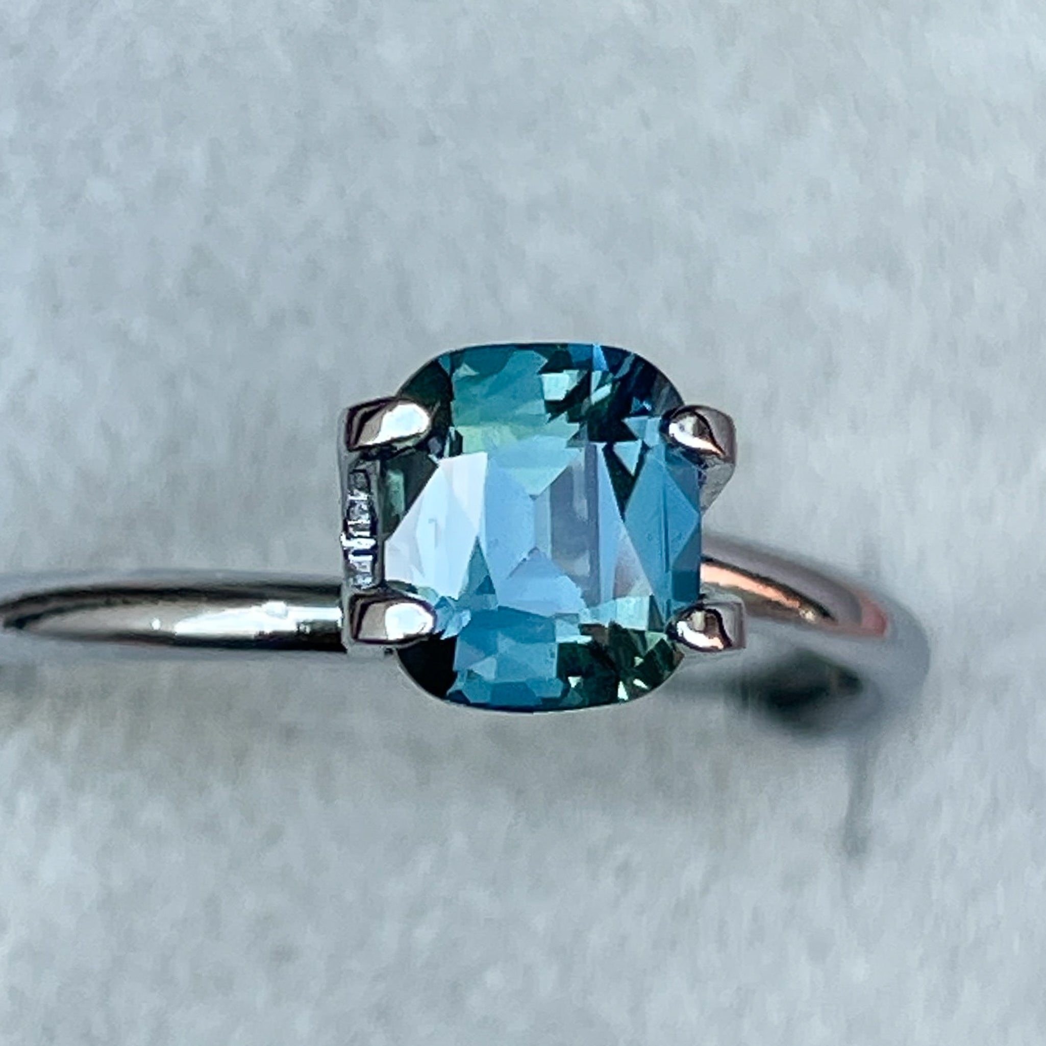Natural teal blue sapphire 1.18 Ct cushion cut loose gemstone by NASHGEMS, perfect for engagement rings or custom jewelry designs.