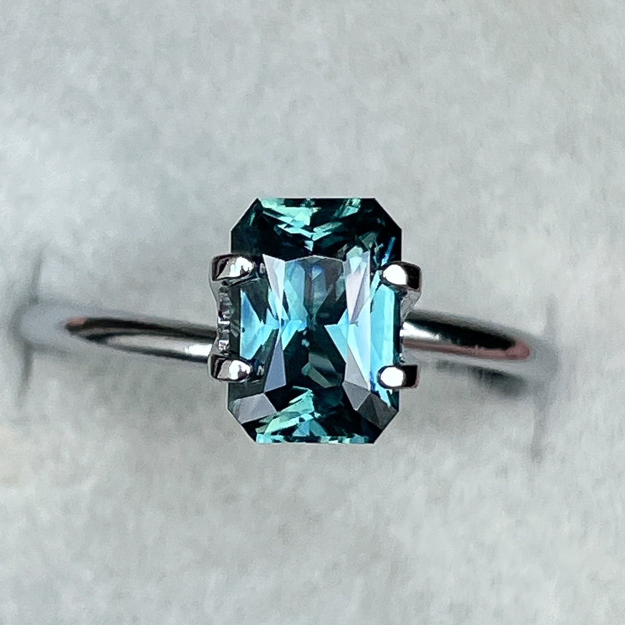 Teal blue-green sapphire 1.71 Ct radiant cut loose gemstone by NASHGEMS, ideal for engagement rings or custom jewelry.