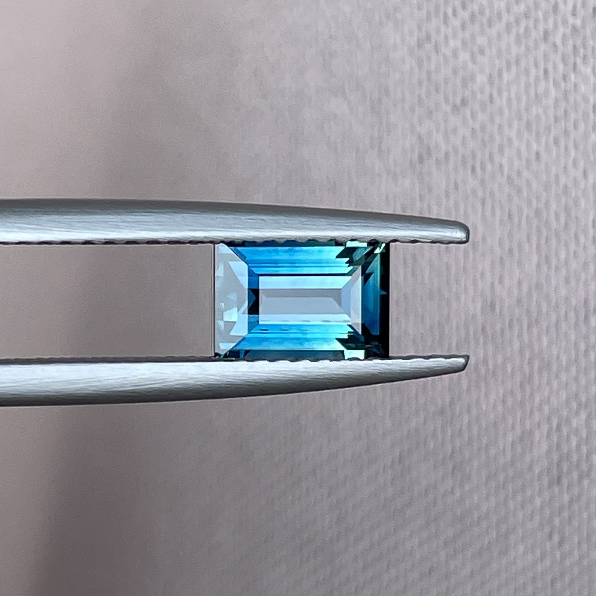 Natural teal blue sapphire, 1.15 Ct baguette cut, loose gemstone from NASHGEMS ideal for engagement rings or custom jewelry.