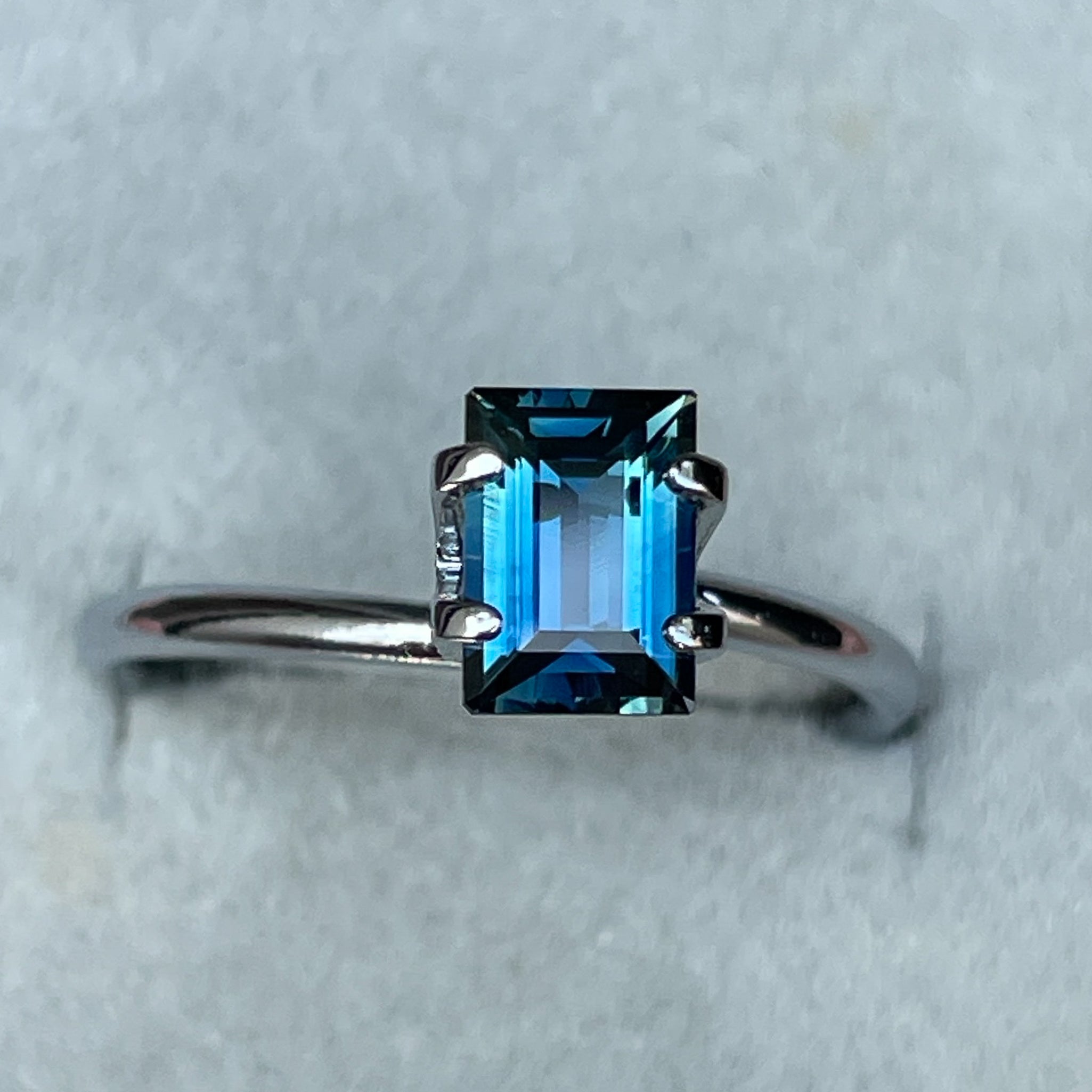 Teal blue sapphire loose gemstone, 1.15 ct baguette cut by NASHGEMS, ideal for engagement rings or custom jewelry.