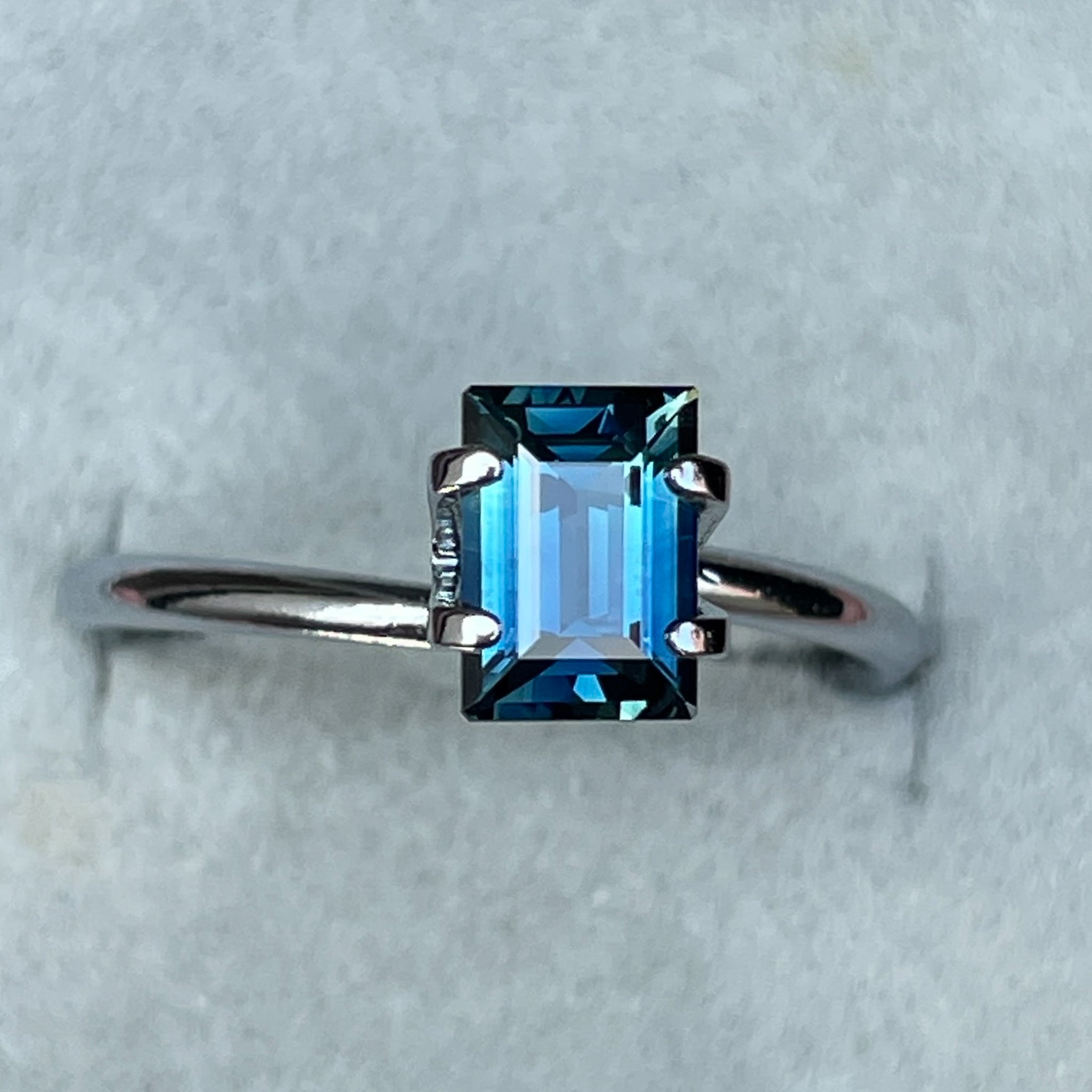 Teal blue sapphire 1.15 ct baguette cut by NASHGEMS, loose gemstone ideal for engagement rings or custom jewelry.