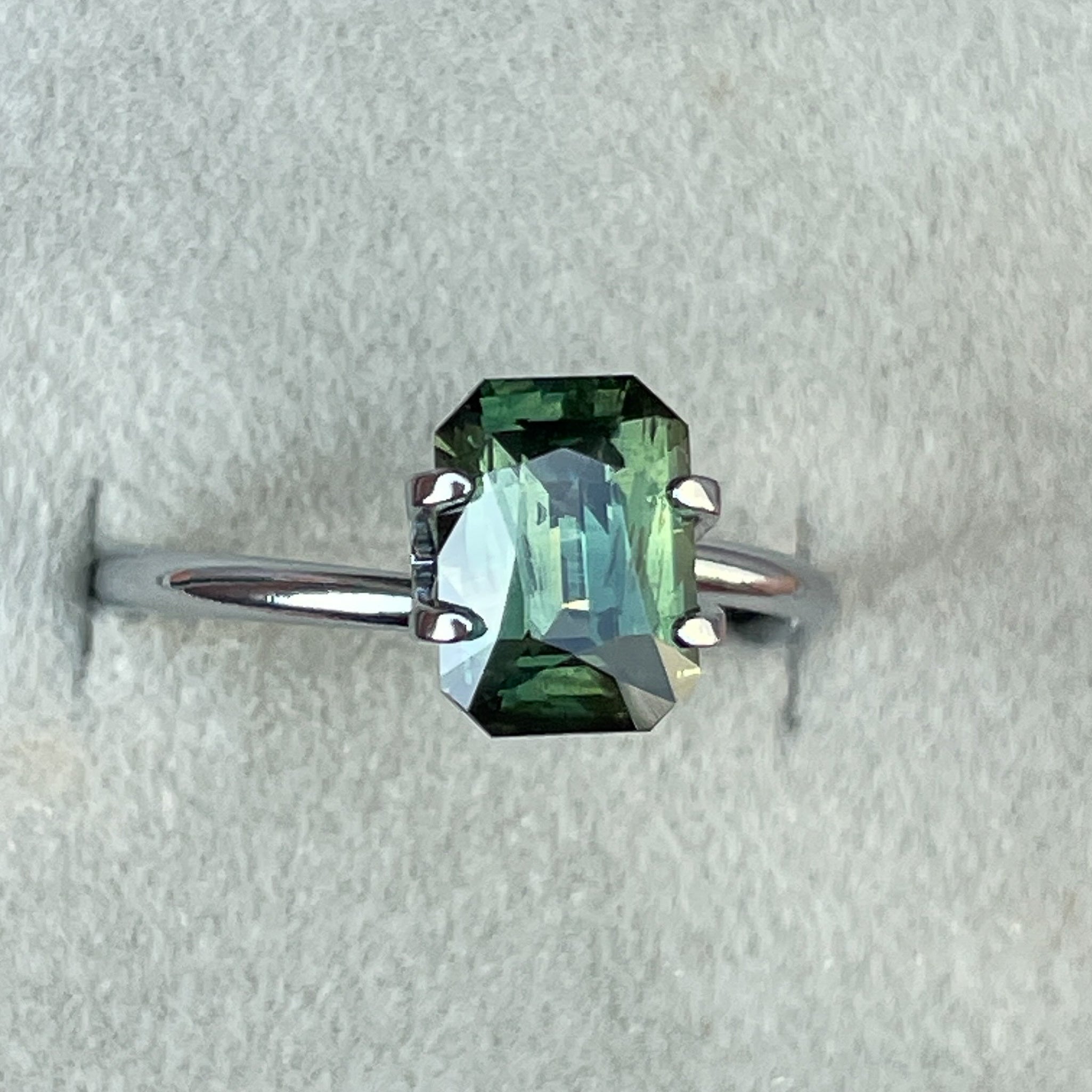 Teal green sapphire 2.36 Ct radiant cut by NASHGEMS, loose gemstone ideal for engagement rings or custom jewelry design.