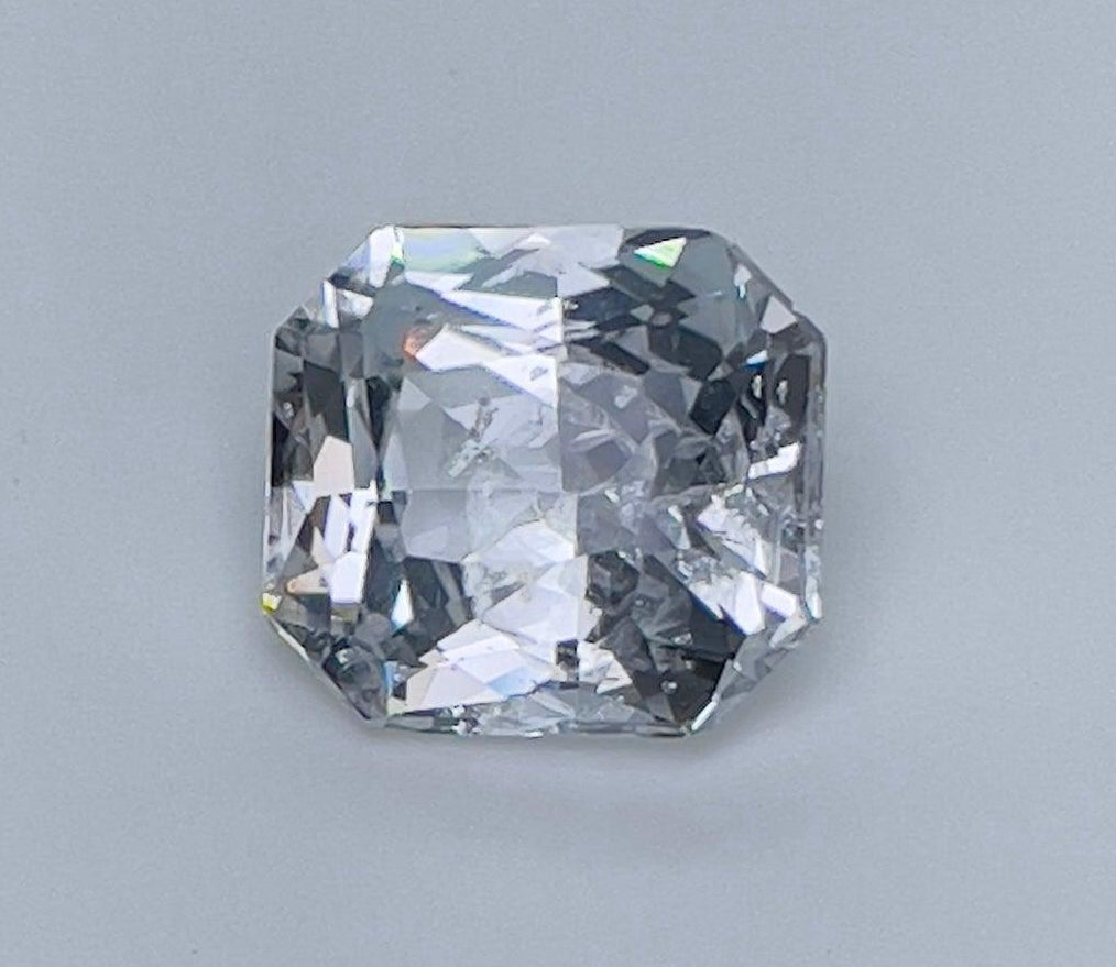 NASHGEMS white sapphire engagement ring with 2.35 carats of off-white sapphires in a elegant white-themed design.